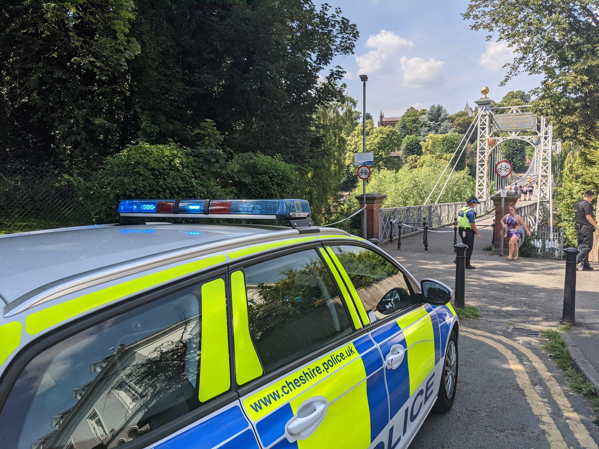 Police at the cordon, blocking off the Queens Park suspension bridge.