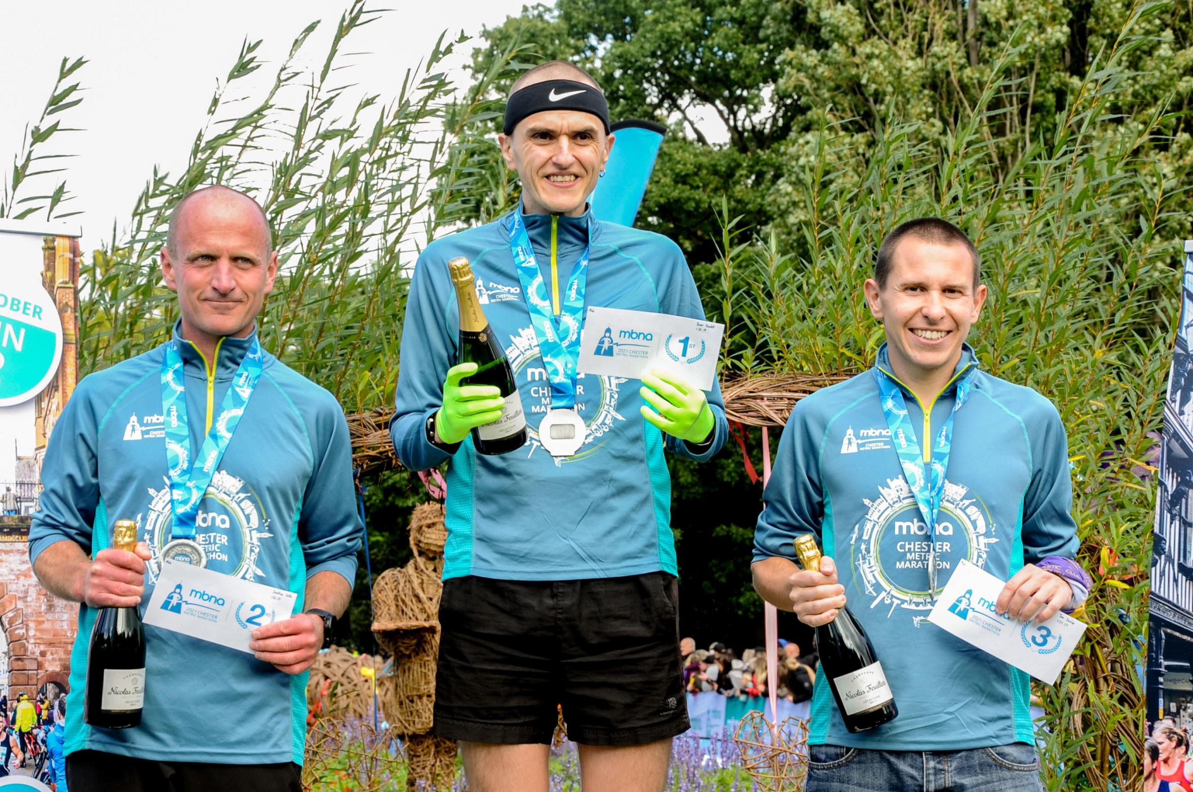 Chester Racecourse start and finish Grosvenor Park, Mbna Chester Marathon, Metric and Mini Marathon. Picture Metric Marathon first man to cross the line Dean Howlett, second place Jonathan Kettle and third place Tom Dunlop. SW03102021.