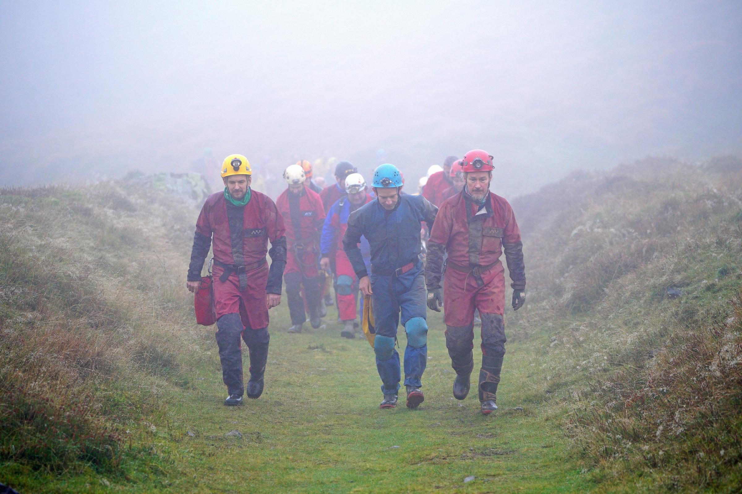 Rescuers walk towards the Ogof Ffynnon Ddu cave system near Penwyllt, Powys in the Brecon Beacons, Wales, as rescue mission is underway to save a man who has been trapped inside a cave, after falling on Saturday. Because of the injuries suffered in the