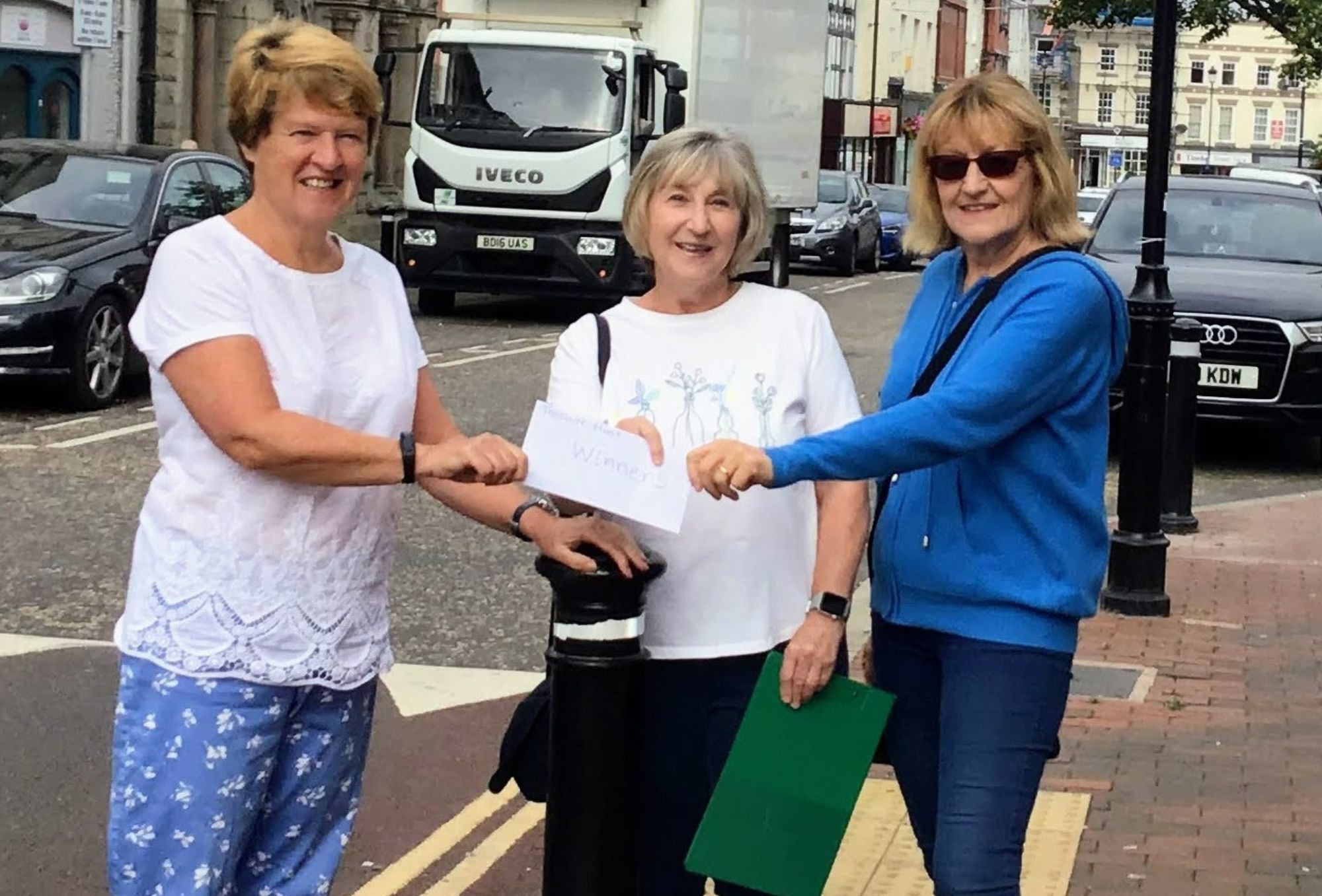 Nia Griffiths, left, presenting the first prize at the Holywell treasure hunt to Barbara Hughes, centre, and Jane Bickerton. 