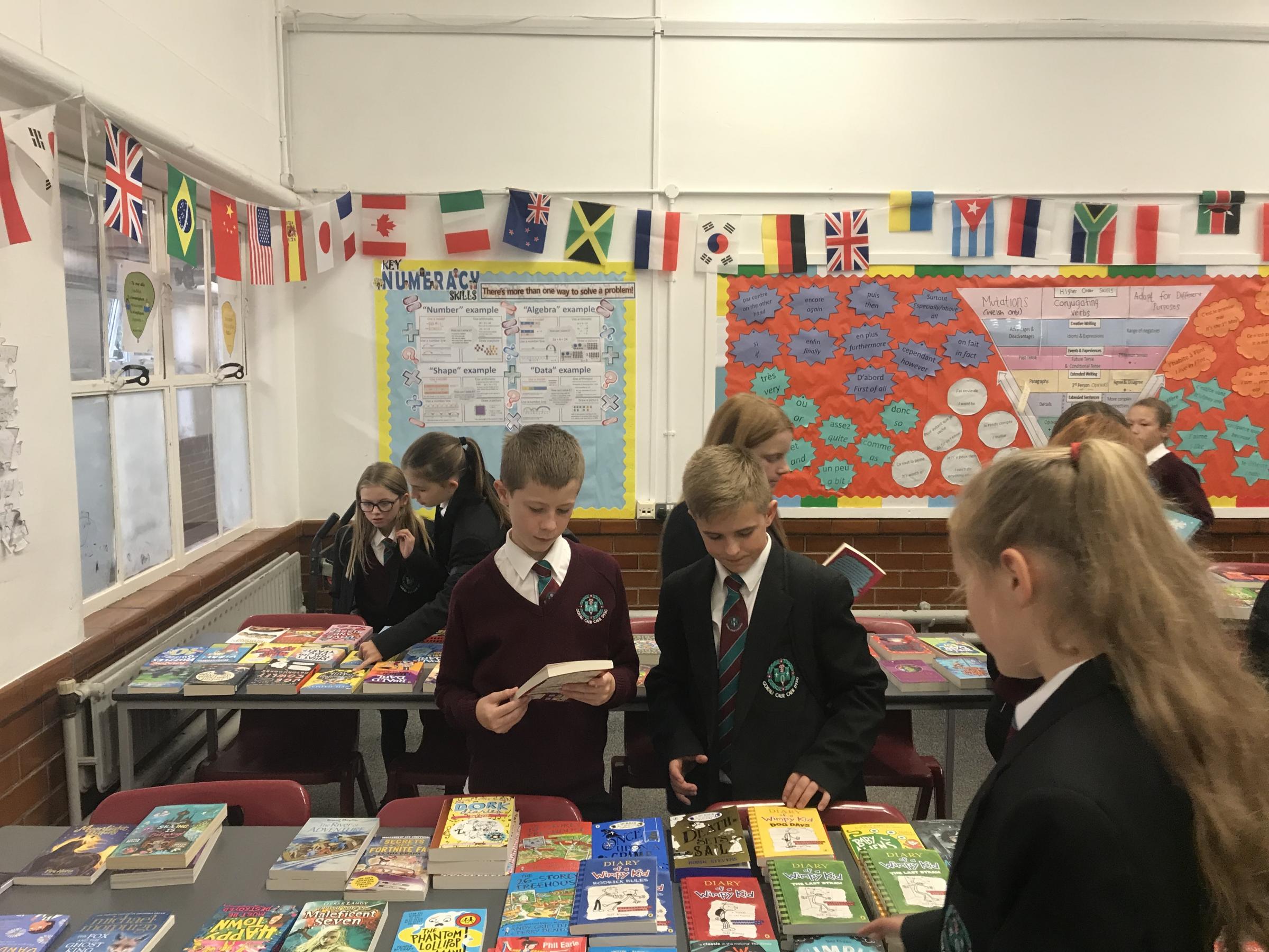 Year 7 students select their books. From left: Fearne Conway, Eva Jones, Oliver Holbrook, Maddox Dakin, Evie Harmes, Chelsea Collo, and Neveah Byles.