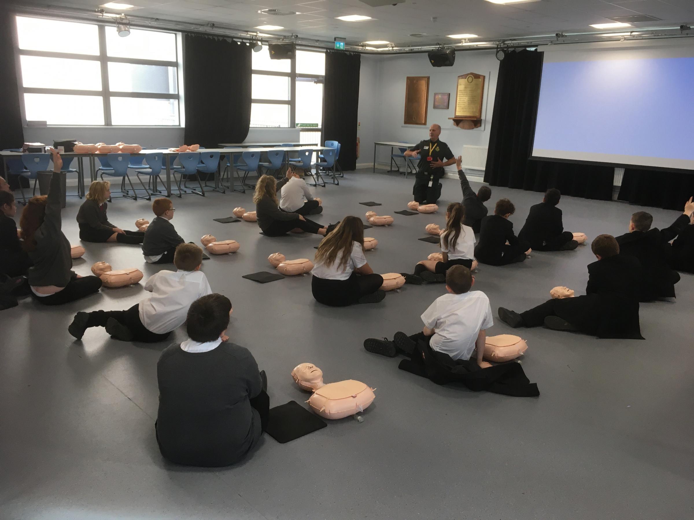 John Goggin explains how to do CPR to the students.