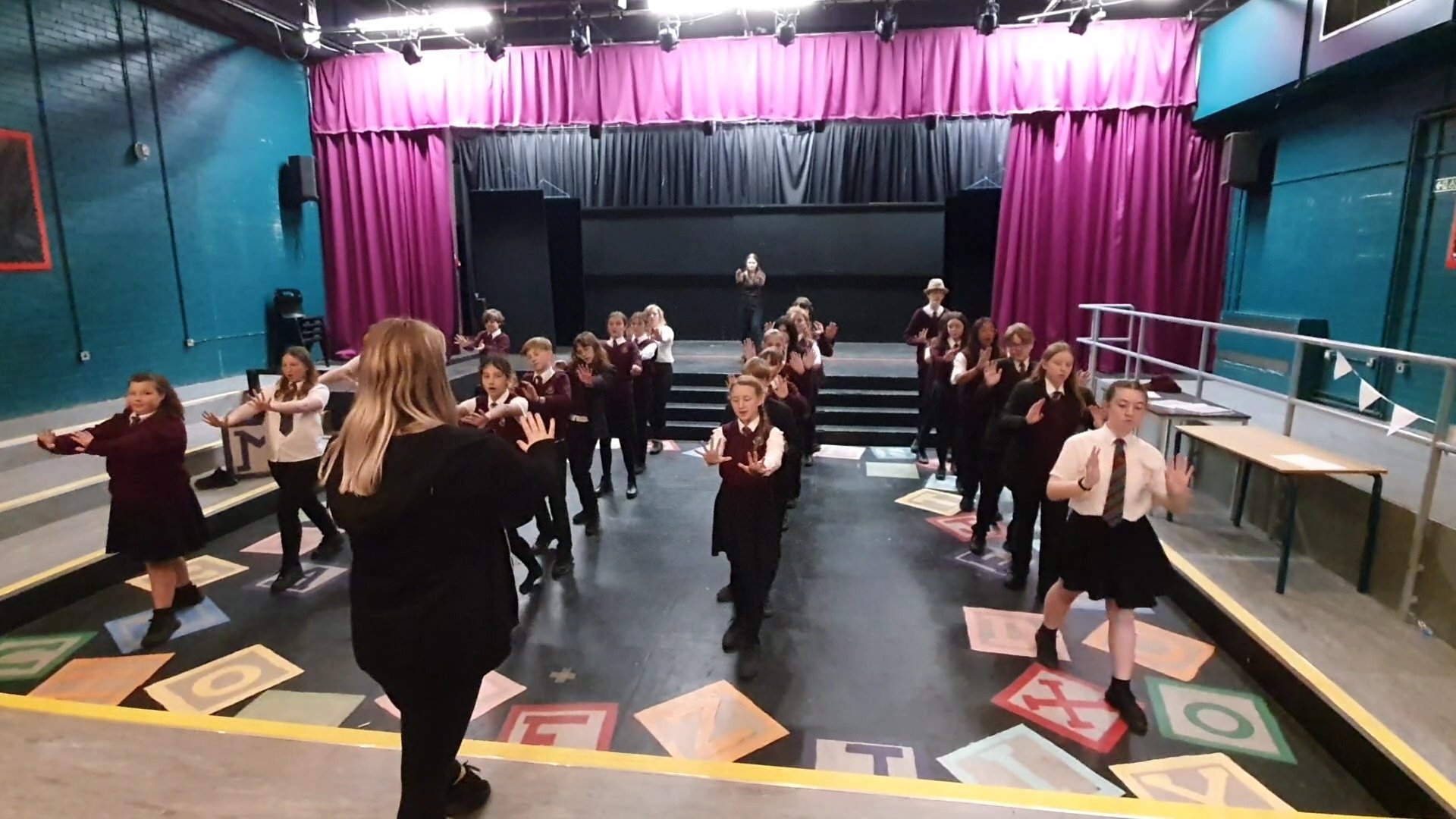 The full cast and assistant choreographer, Leah Jones, rehearsing Radio Gaga, the opening number to the show. 