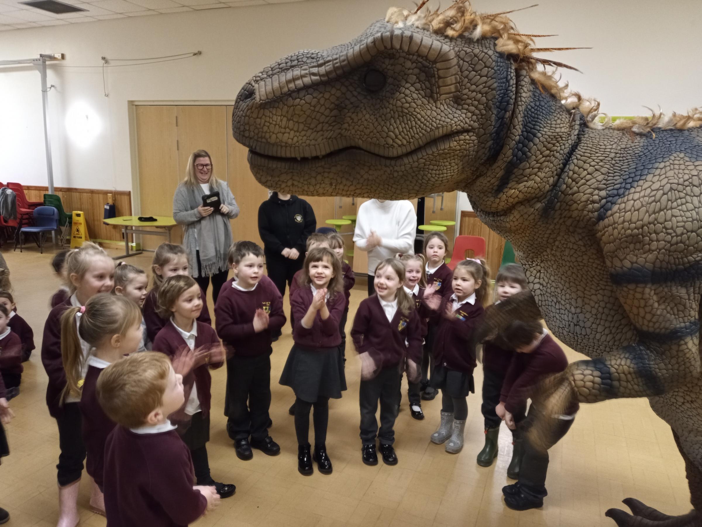 Getting up close to a t-rex with Dinomania at Park CP School, Llay.