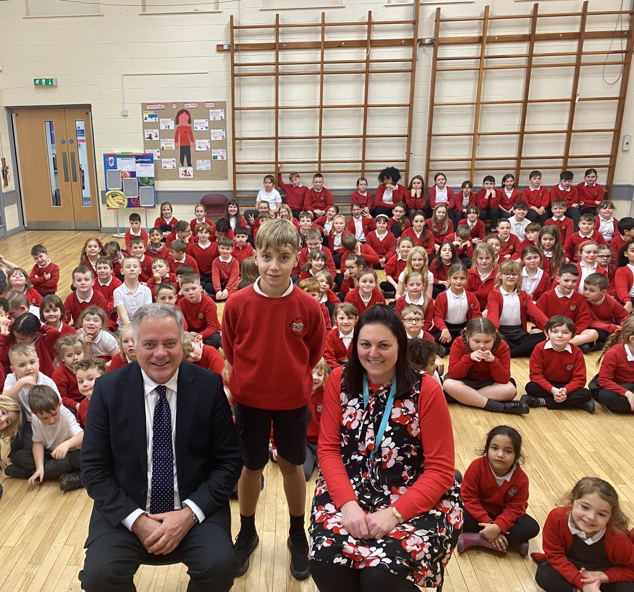 Simon Baynes MP with Christmas card competition runner-up Luca Burgoyne, and Ysgol Bryn Collen headteacher Lisa Howden.