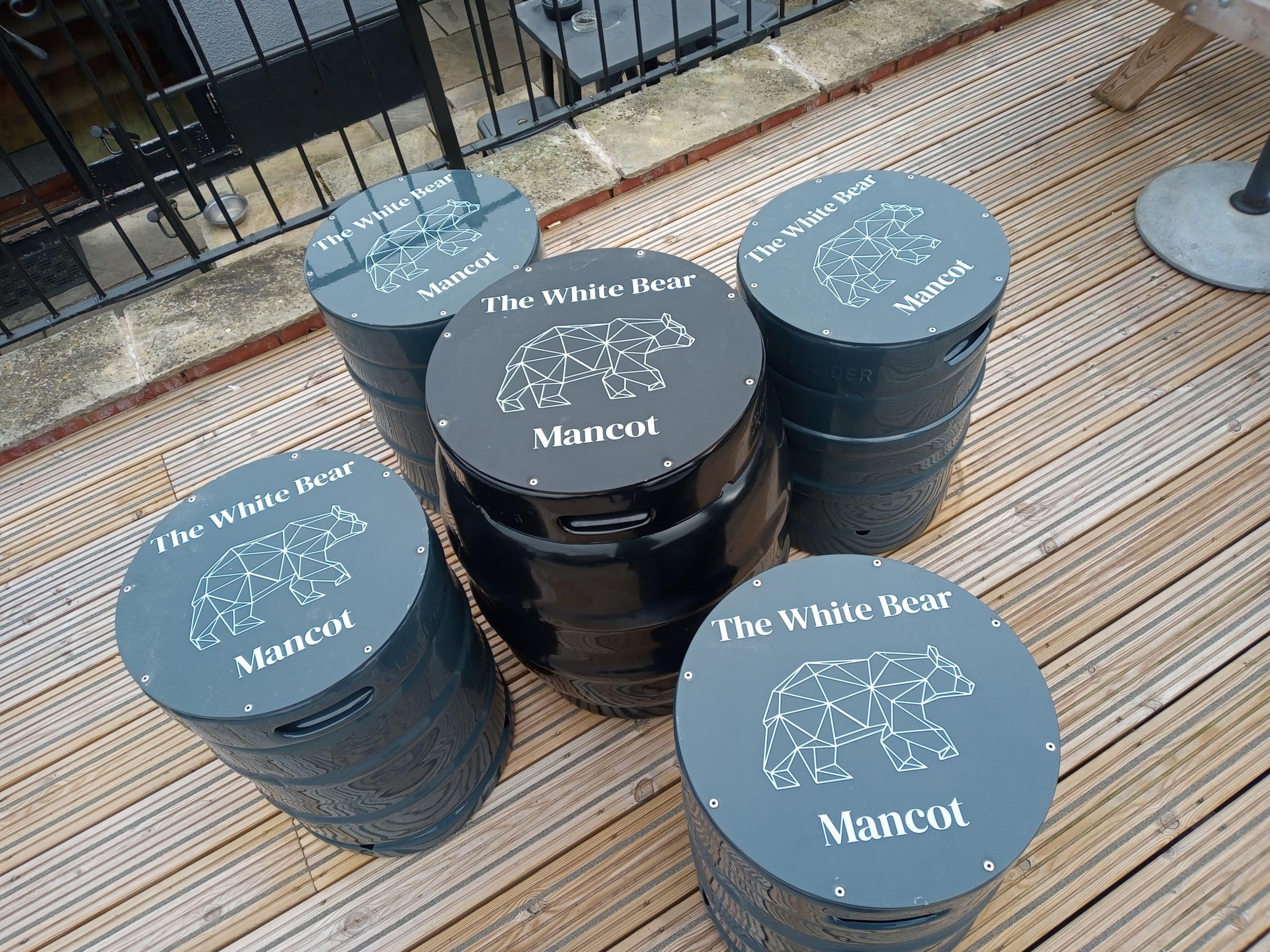 Seating and a table made from used barrels at the White Bear in Mancot, with the logo designed by landlady Hayley Selvester.