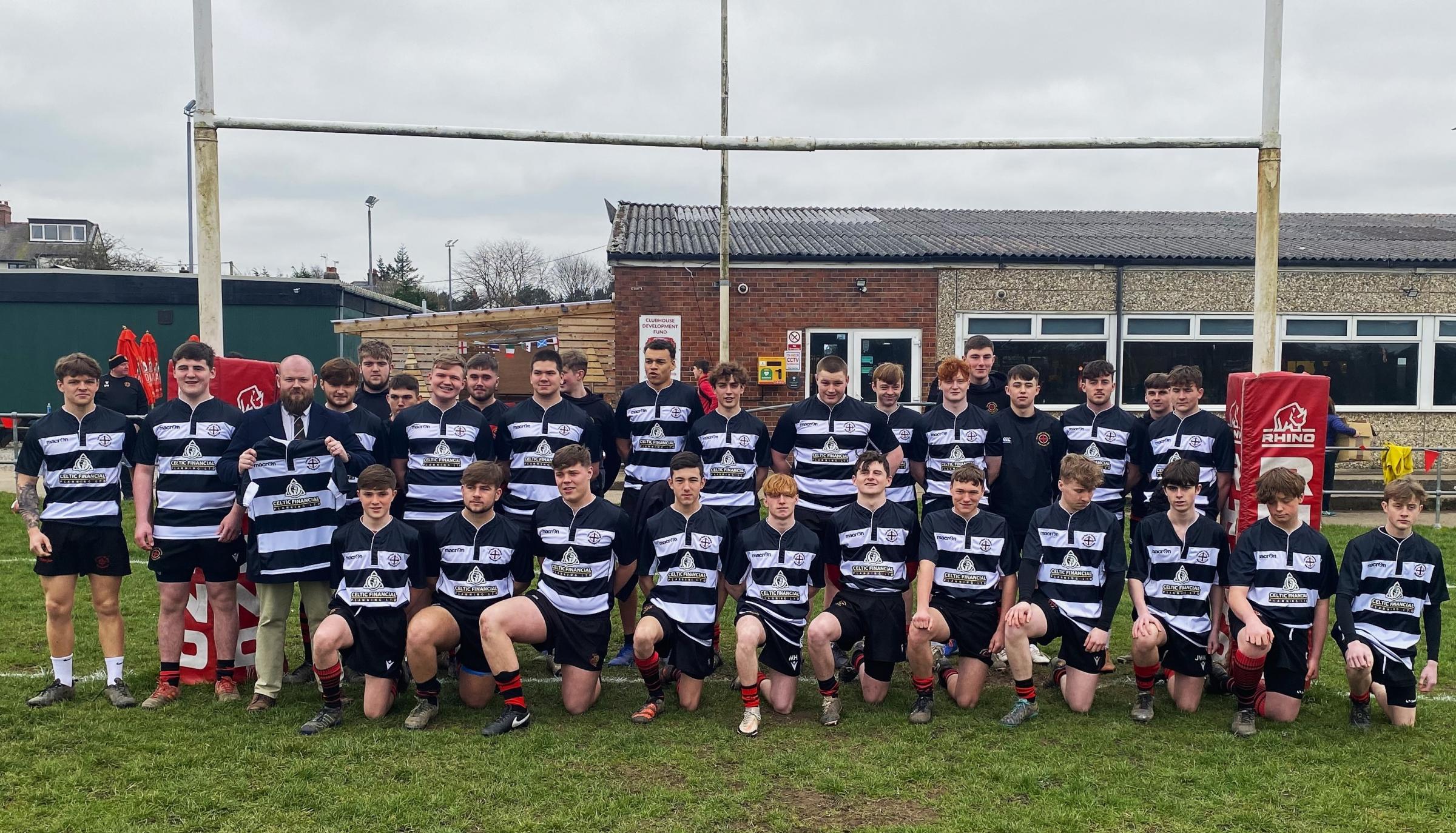 Rob Lewis from Celtic Financial Planning with players from Mold RFC youth development squad.