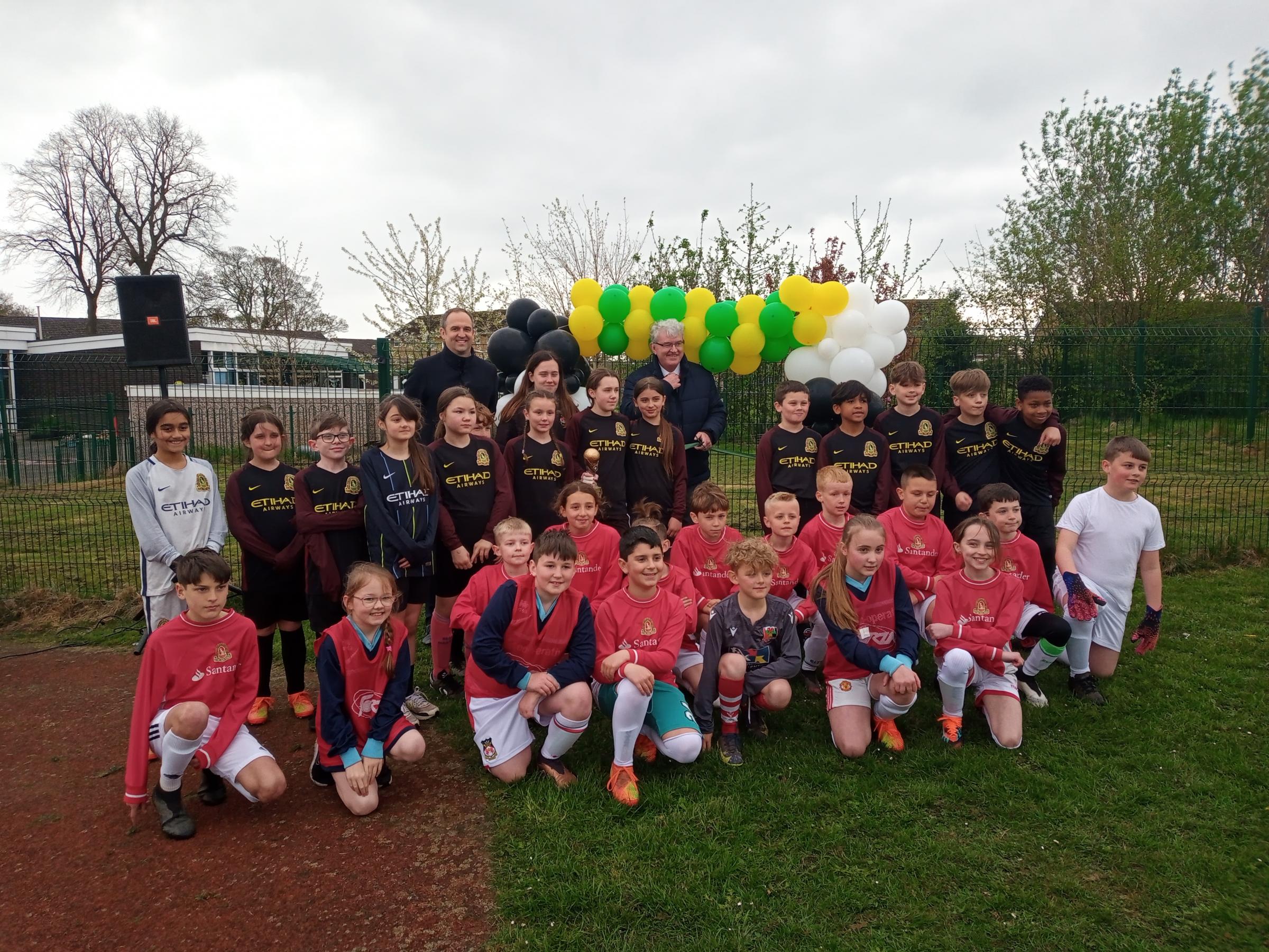 Jonathan Miller and Cllt Phil Wynn with members of the girls and boys football teams.