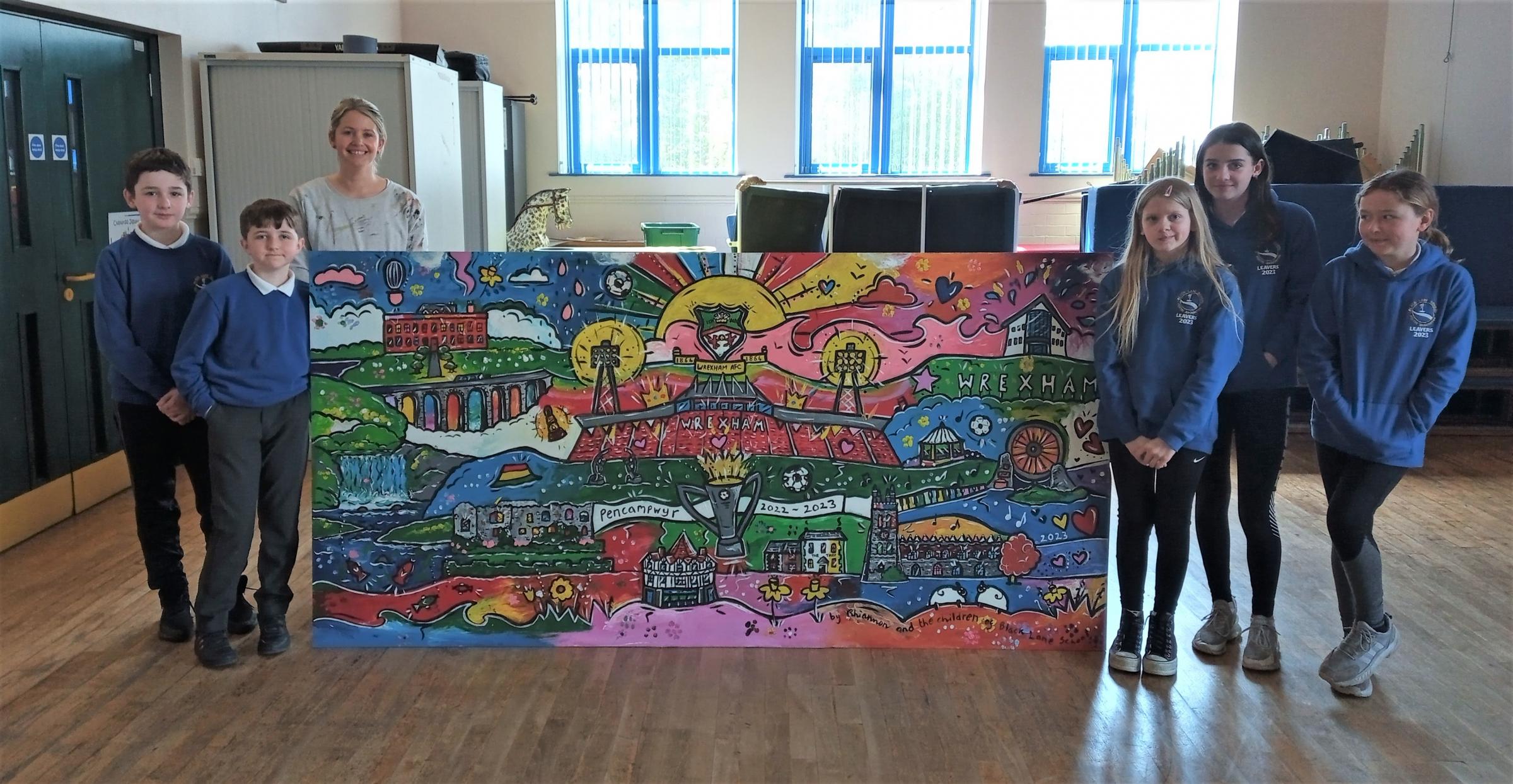 Black Lane CP School pupils and artist Rhiannon Roberts, with the Wrexham themed artwork.