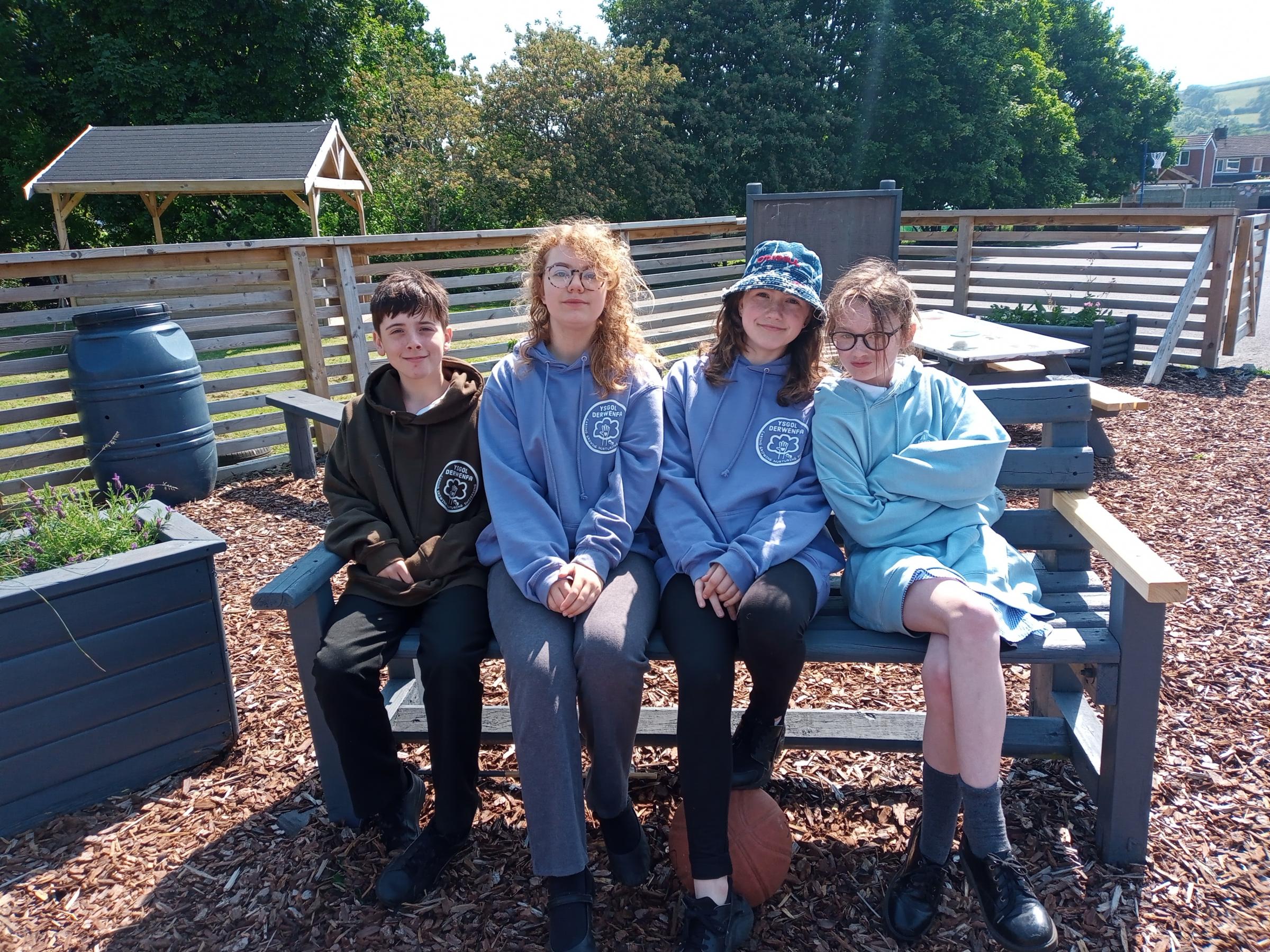 Elliott Graham, Yeva Parry, Summer Thomas-Bradbury and Jessica Challinor in the sensory garden at Ysgol Derwenfa.