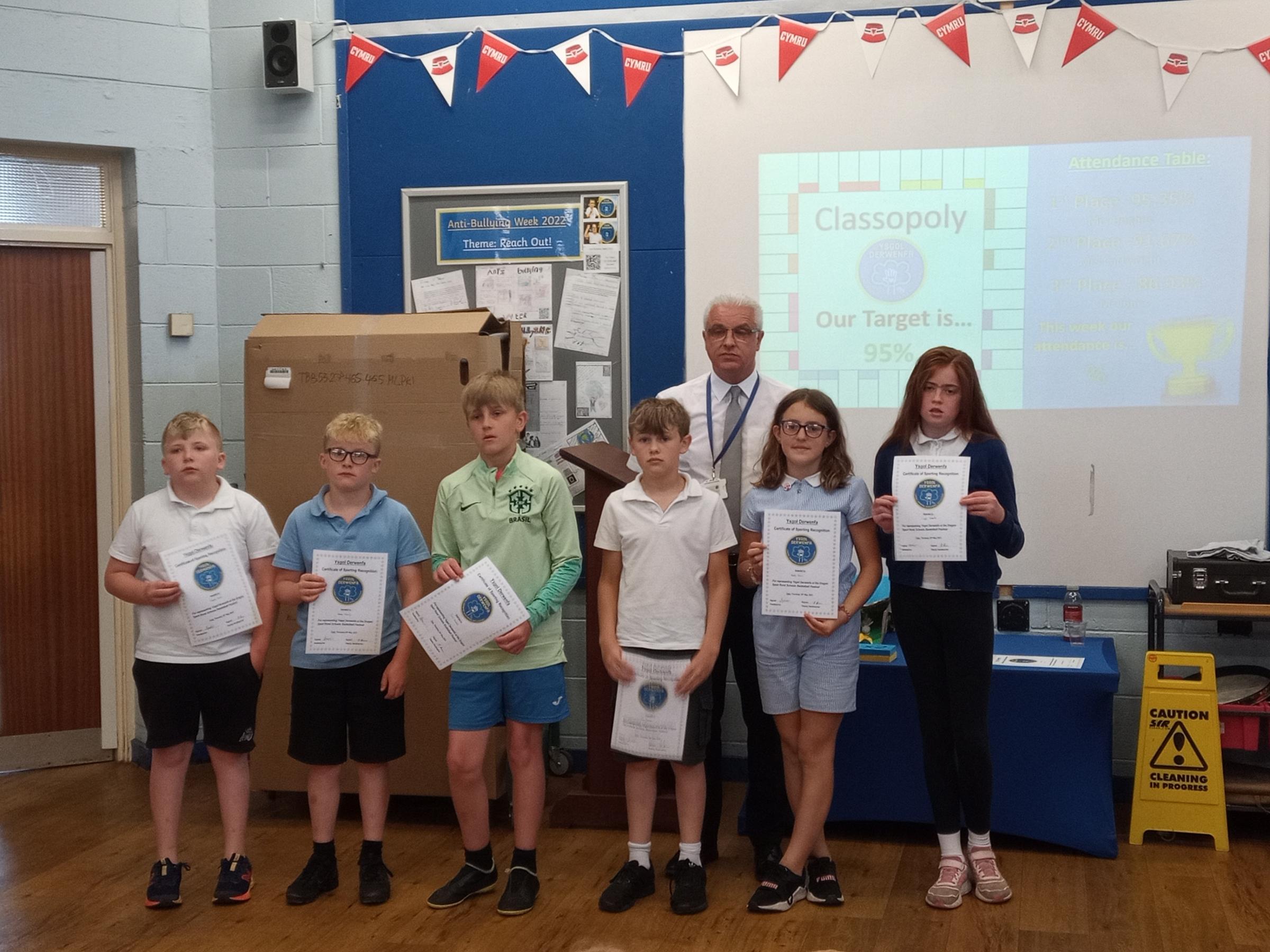 Headteacher Andy Jones with members of Ysgol Derwenfas basketball team.