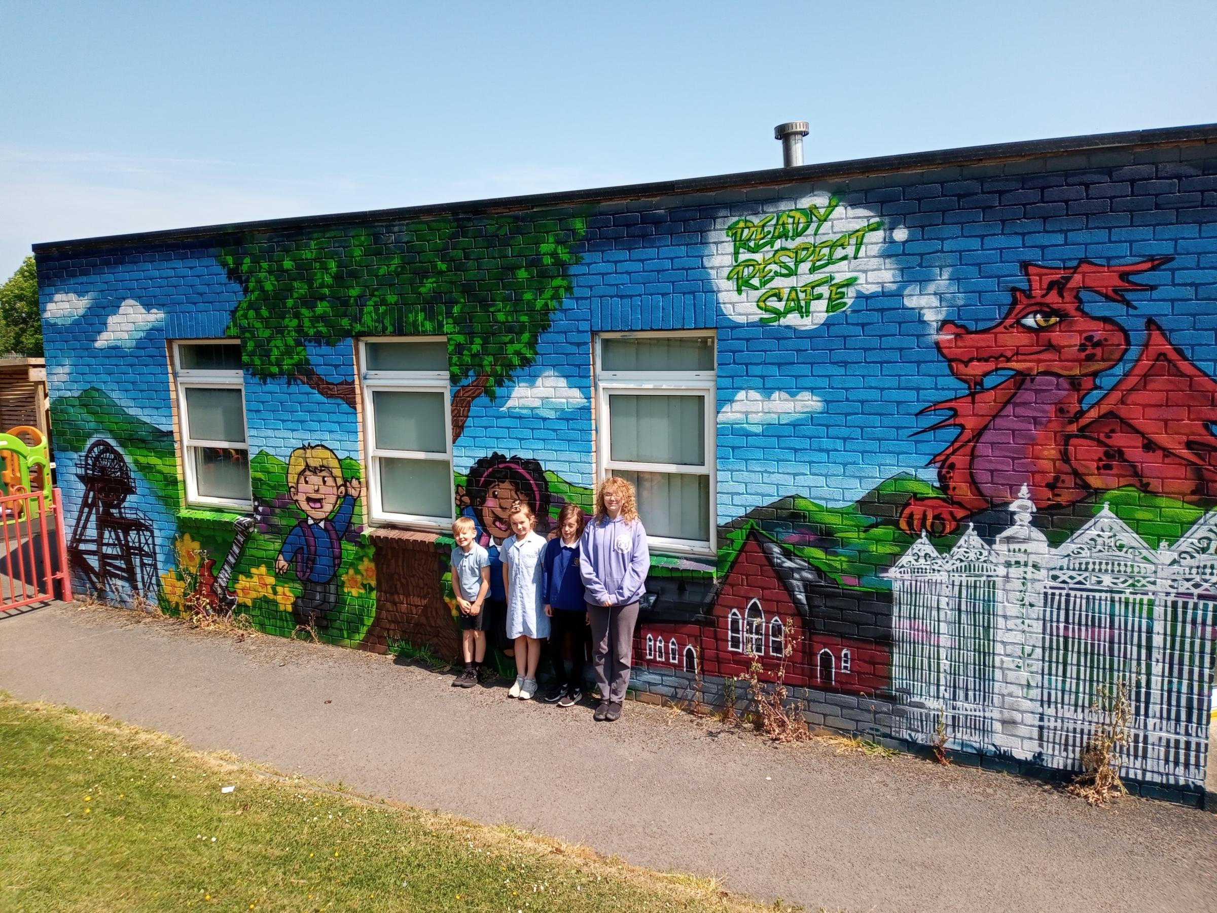 Yeva Parry, Jasper Halfpenny, Isabella Kendrick and Libby Harrison show off their school mural.