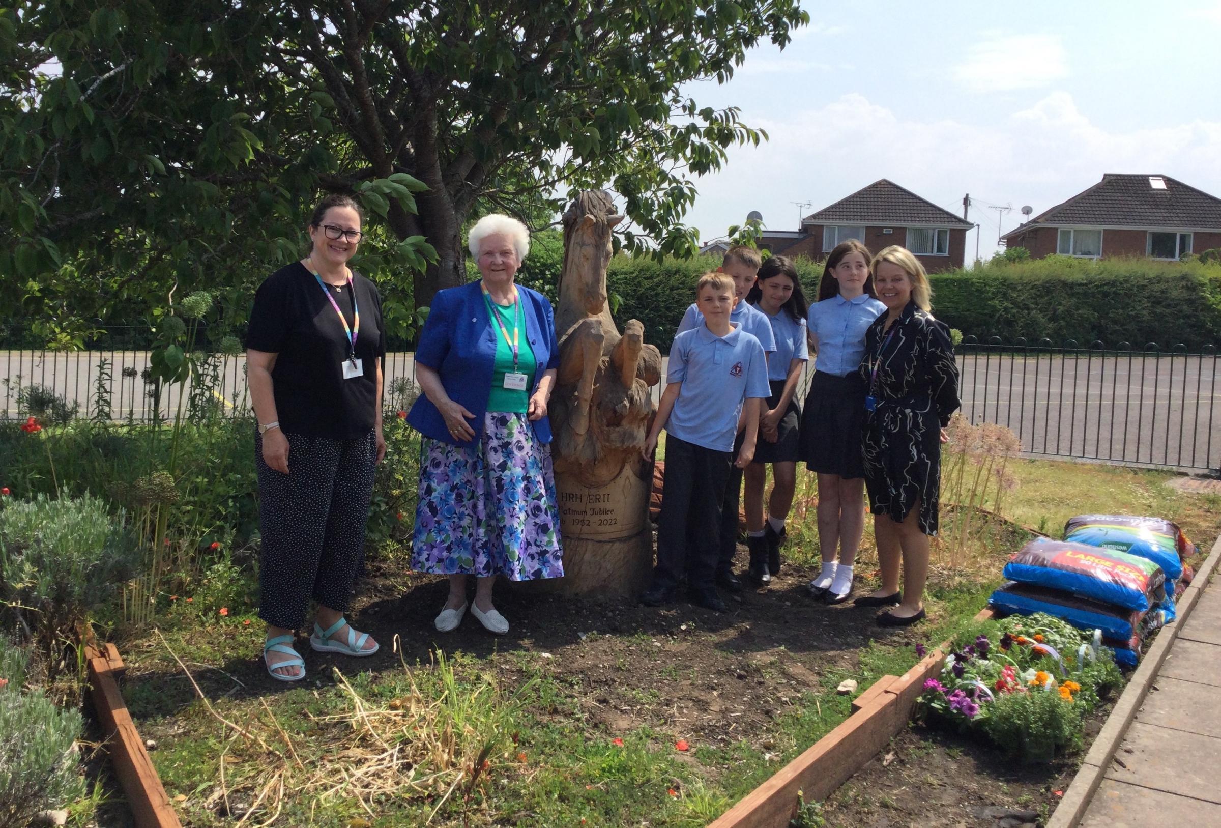  Pictured with Queenie are pupils who were part of the design, headteacher Rebecca Langley, class teacher Angie Doyle, and vice chair of the council Doreen Mackie.