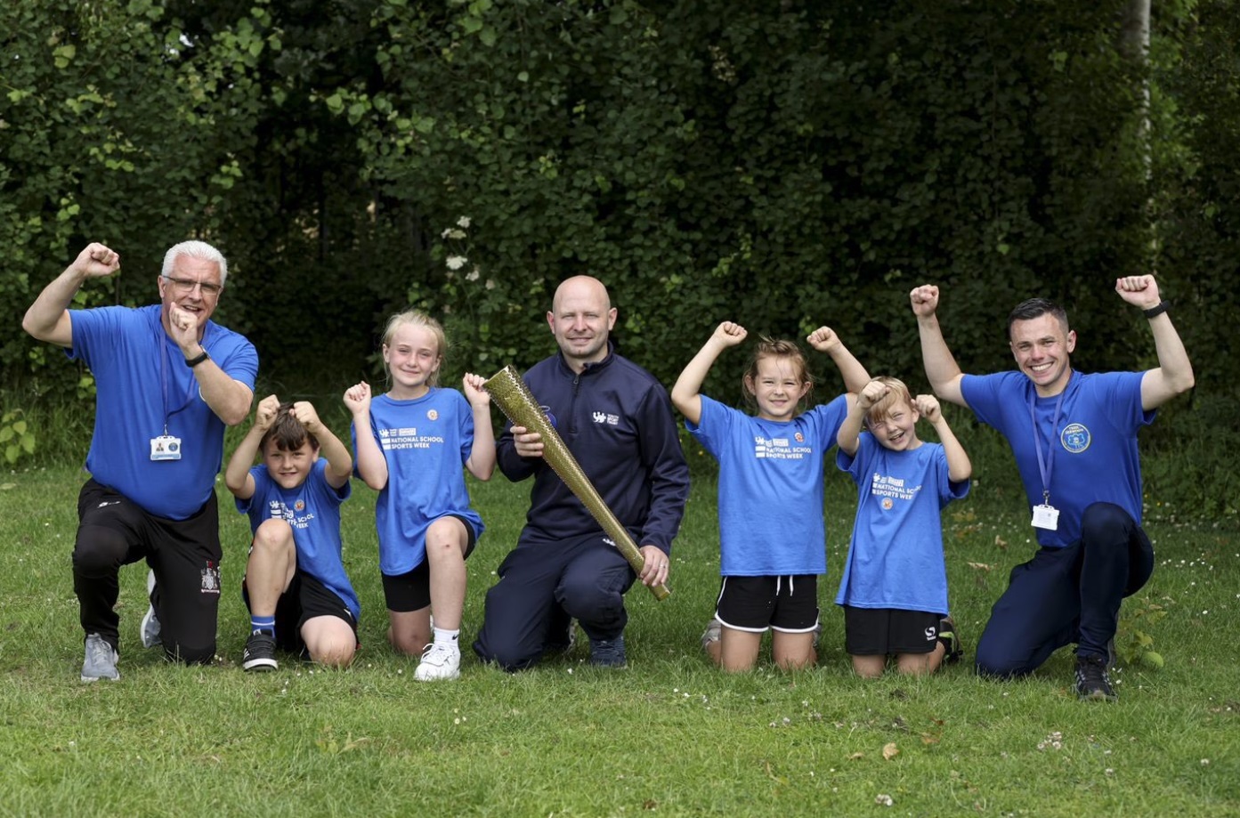 Headteacher Andy Jones,Youth Sports Trust developmenet manager Wales, Steve Thomas and deputy headteacher John Jones, with pupils during National School Sports Week.