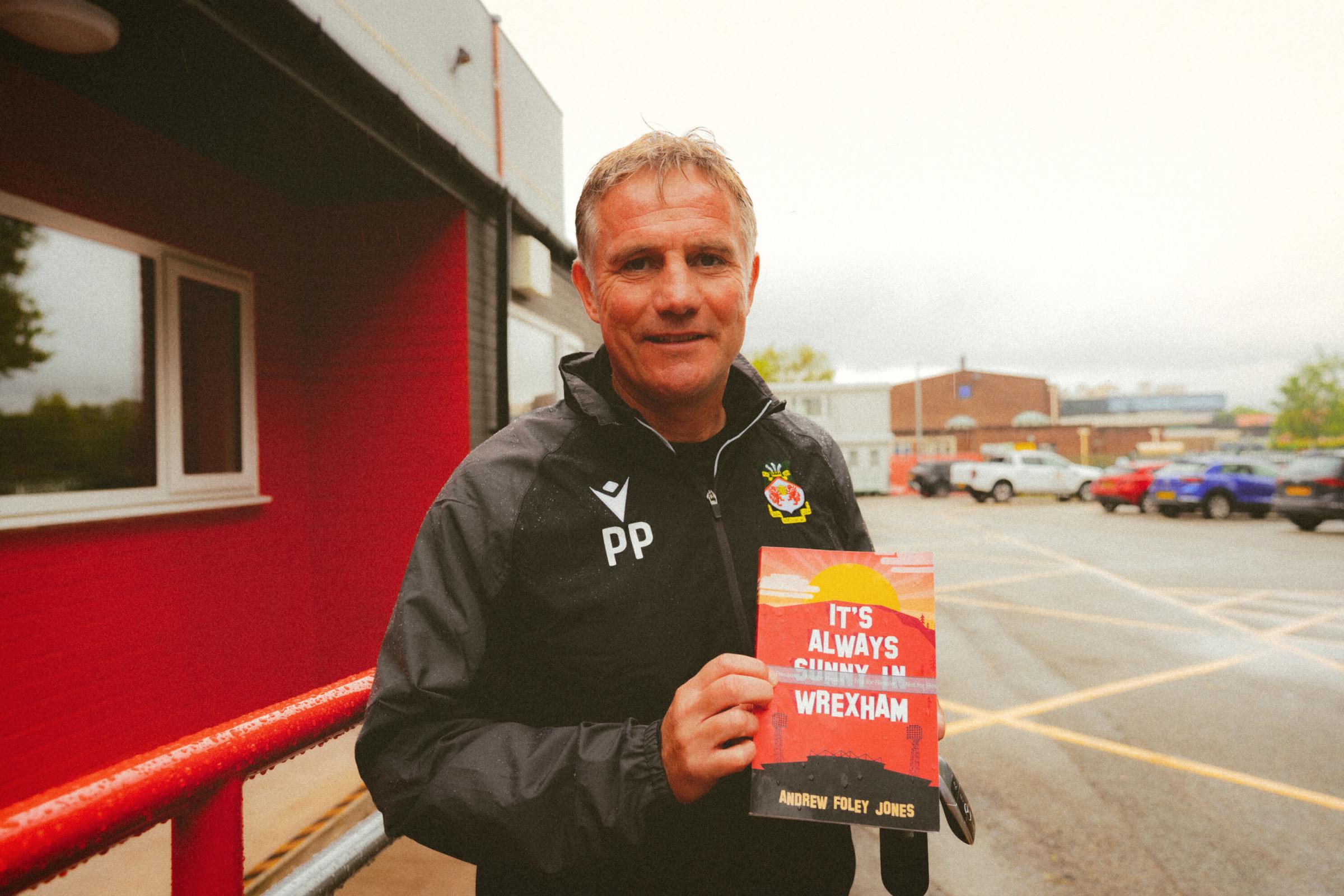 Wrexham AFC manager Phil Parkinson with a copy of Its Always Sunny In Wrexham.