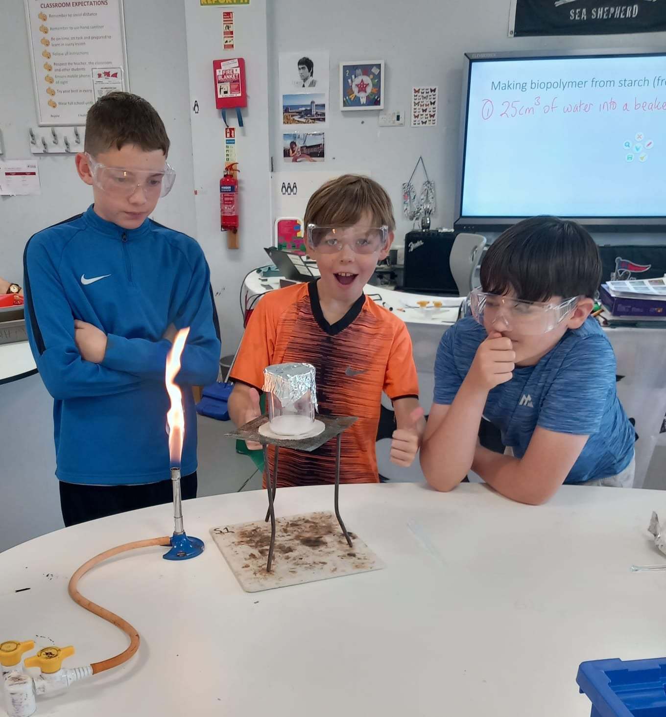 Boys have fun with an experiment in a science workshop.