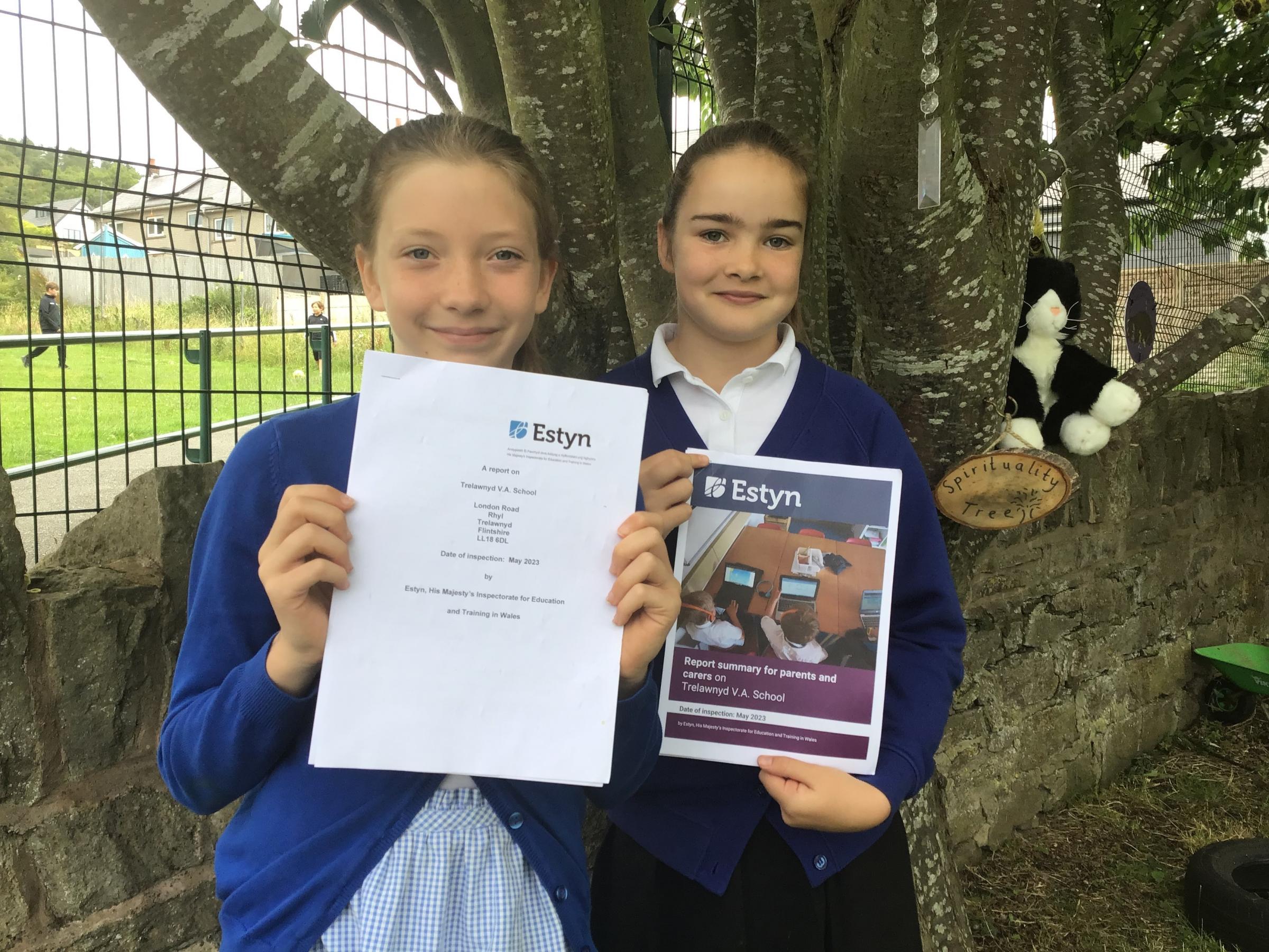 Ysgol Trelawnyd VA School pupils Cari and Daisie with the schools Estyn report.