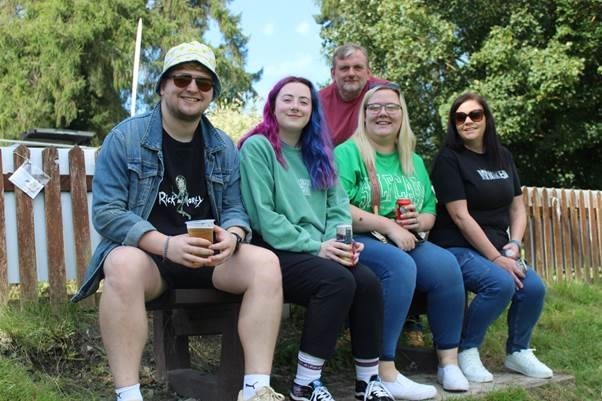 Enjoying the sunshine as well as a barbecue and bar.