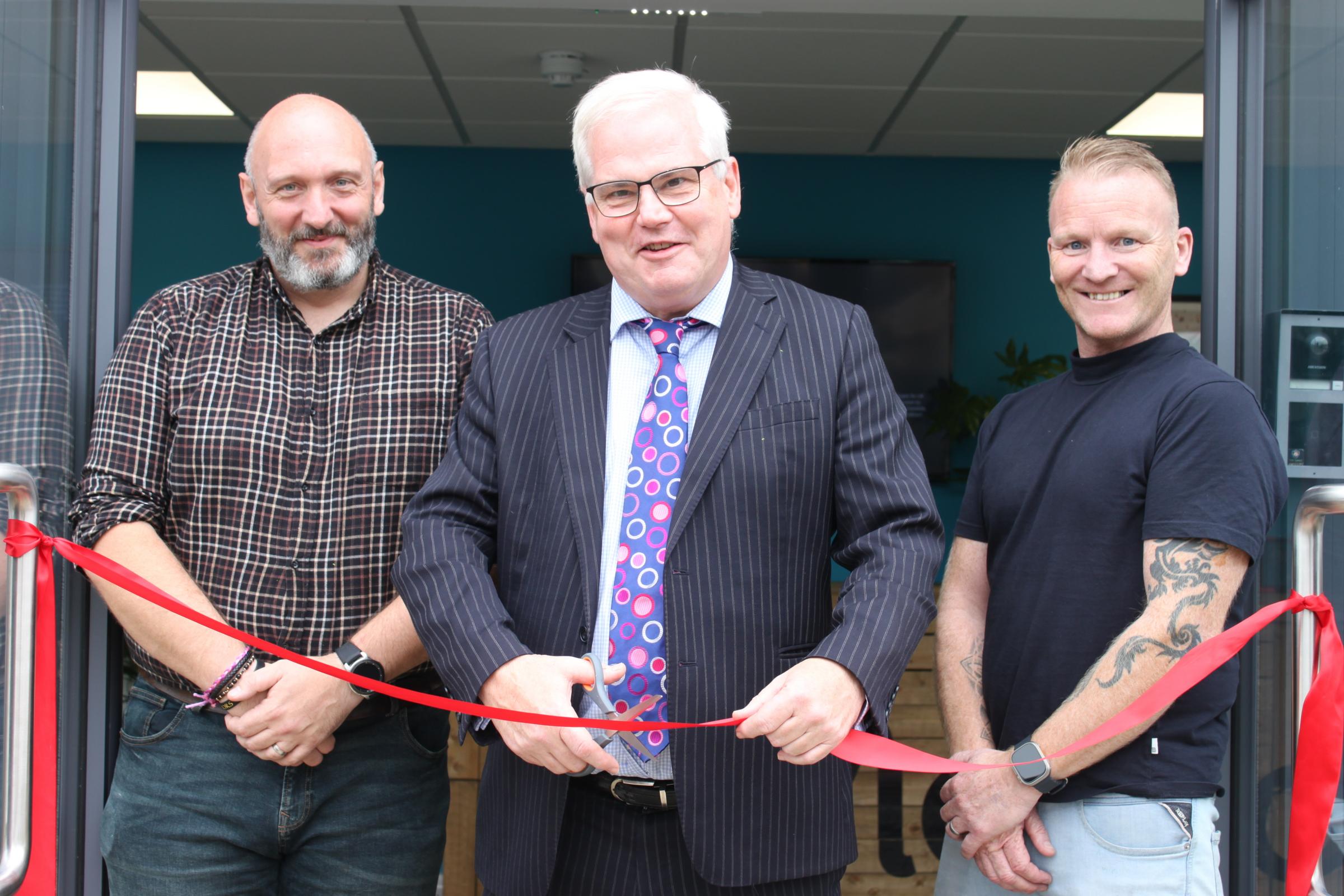 David Ditcham and Jon Spencer watch on as MP Mark Tami opens their Deeside site.