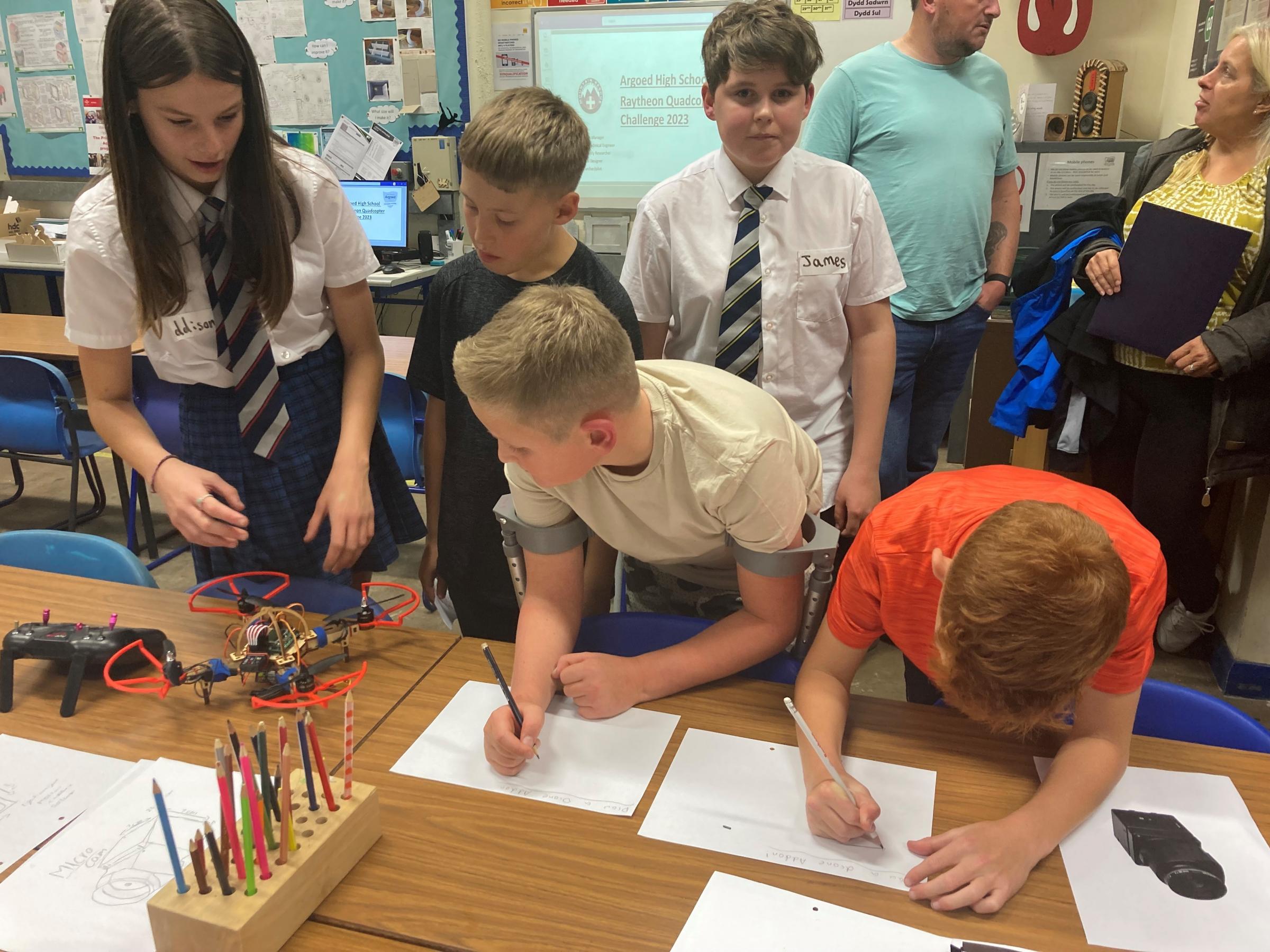 Maddison Jones and James Richards, Year 9, showing projects on the laser cutter.