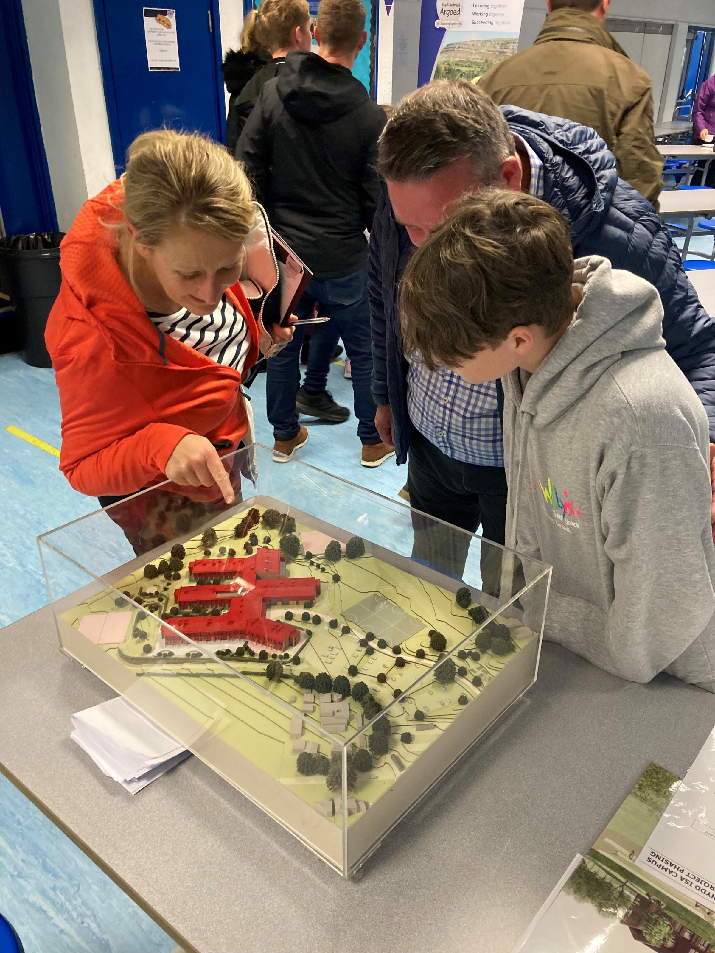 A family view the new build model and plans.