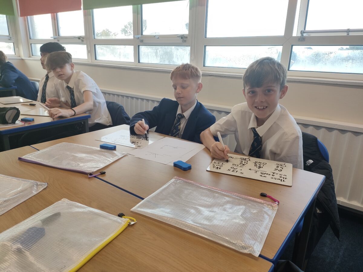 Year 8 pupils at Ysgol Rhiwabon, solving maths problems.