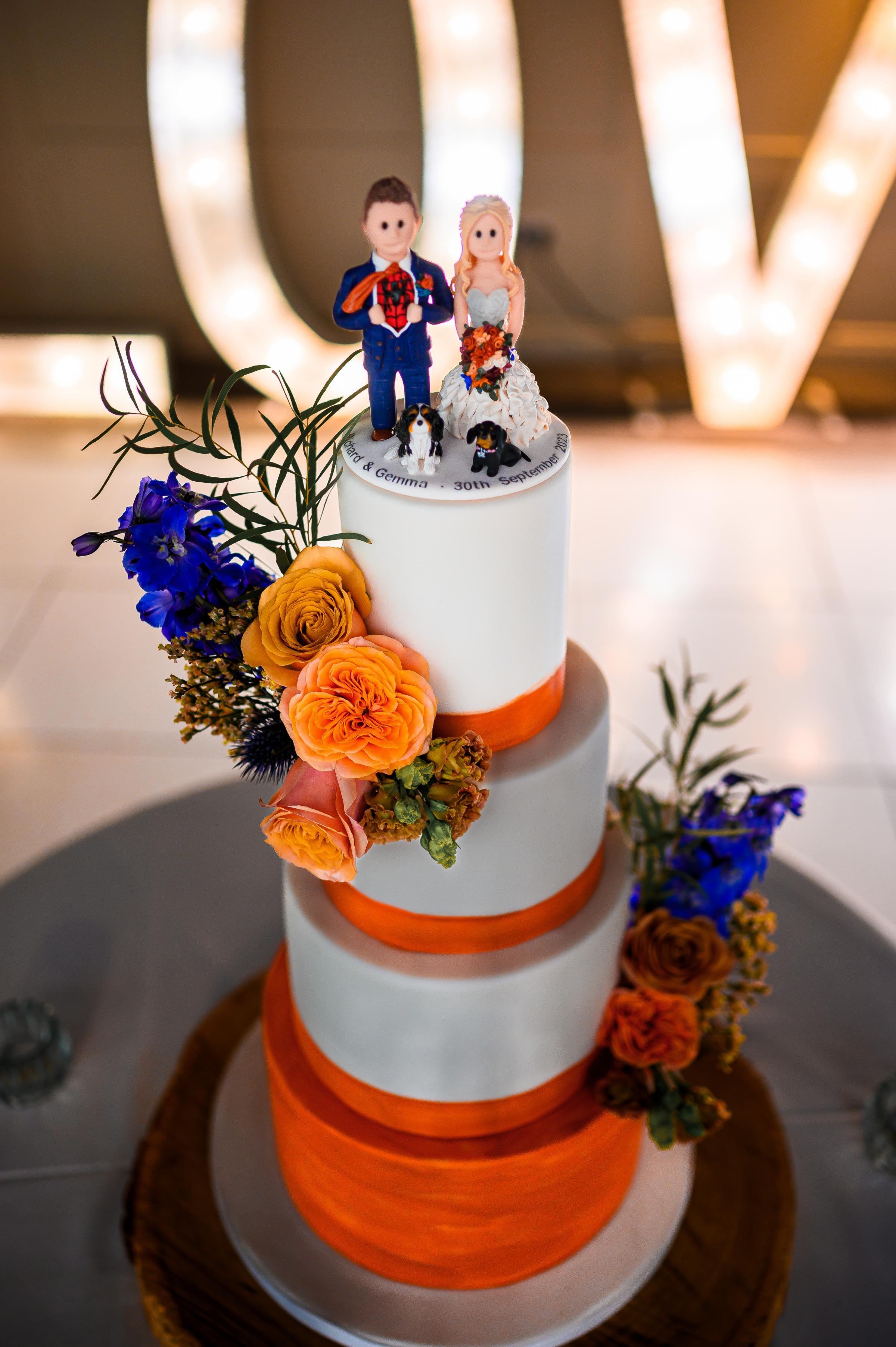 Gemma and Richard Jones amazing wedding cake made by Julie at Red Rose Company, and their cake topper, made by Sarah from Feats of Clay