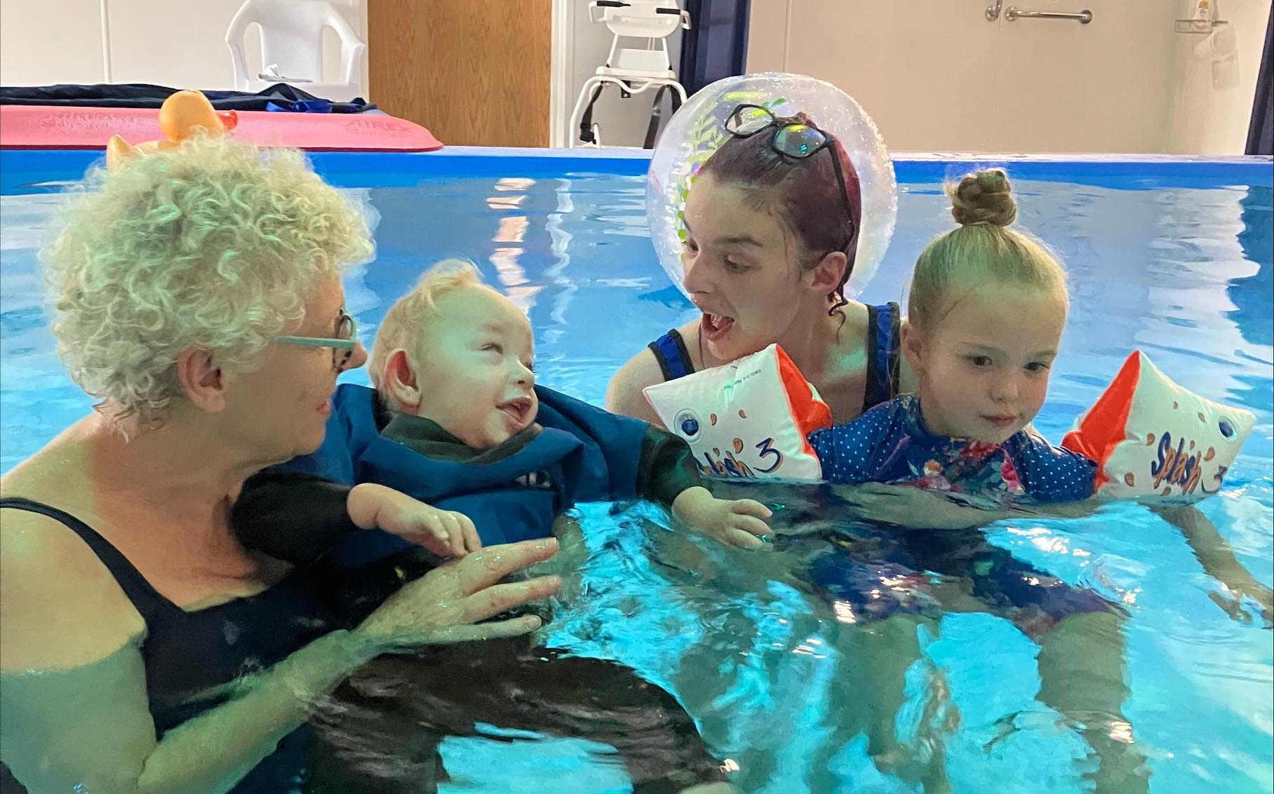 Theos first swim with mum Laura Williams, sister Esmae and Hope House physiotherapist Ula Chambers.