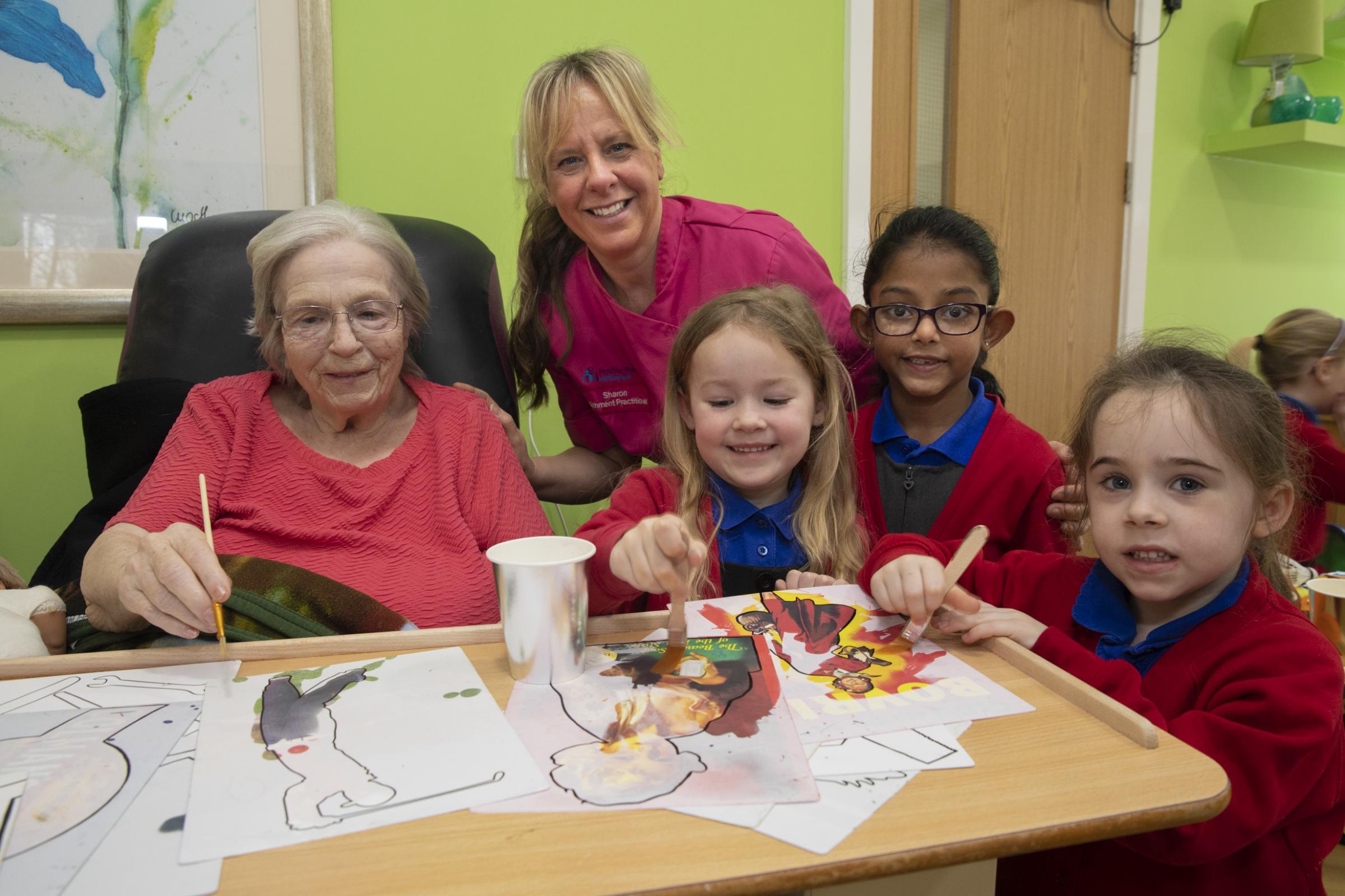 Resident Betty Newcombe with Sharon Williams of Highfield and pupils Oliwia, Tenushe and Isla. Photo: Mandy Jones