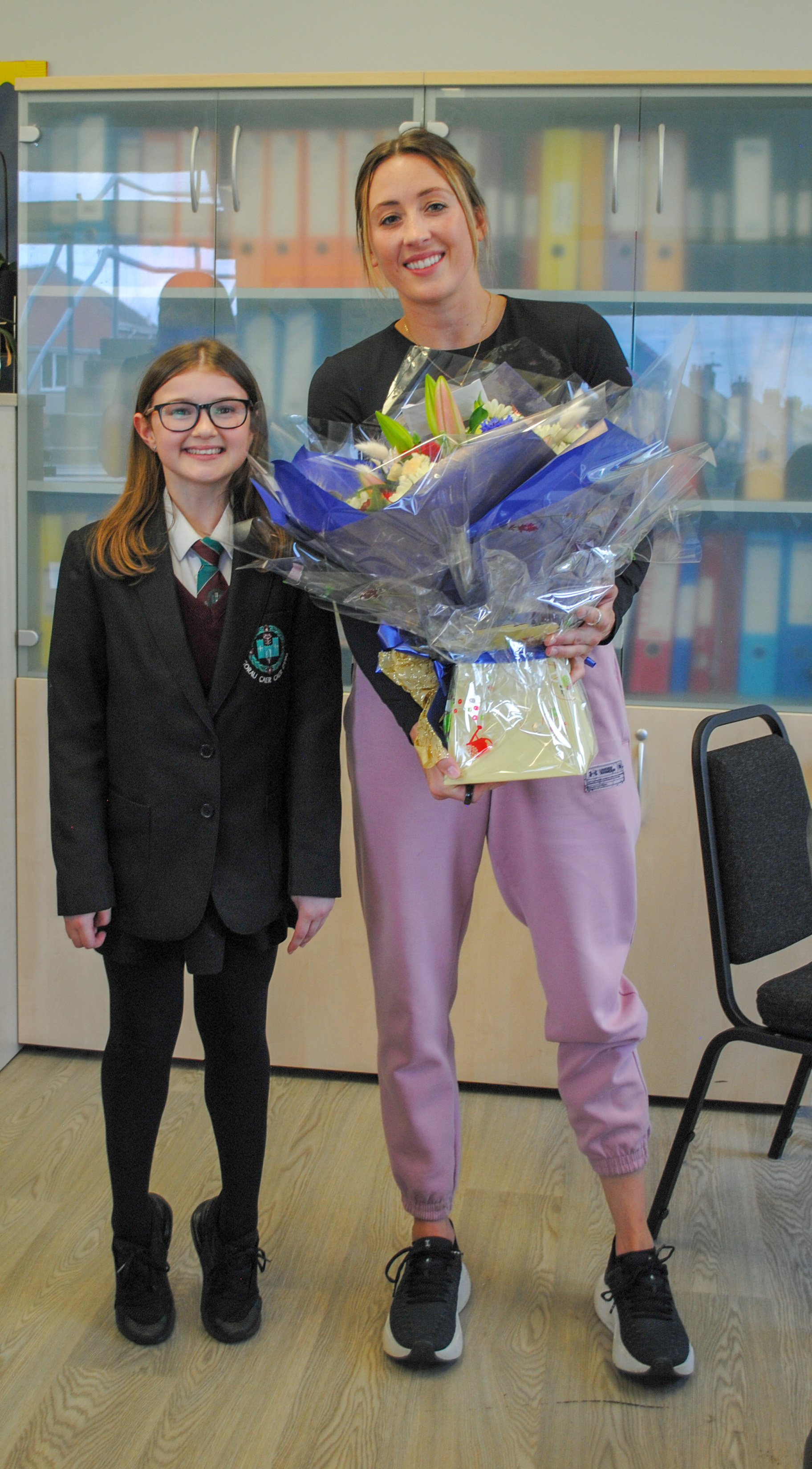 Daisy Brown presents a bouquet to Jade Jones.