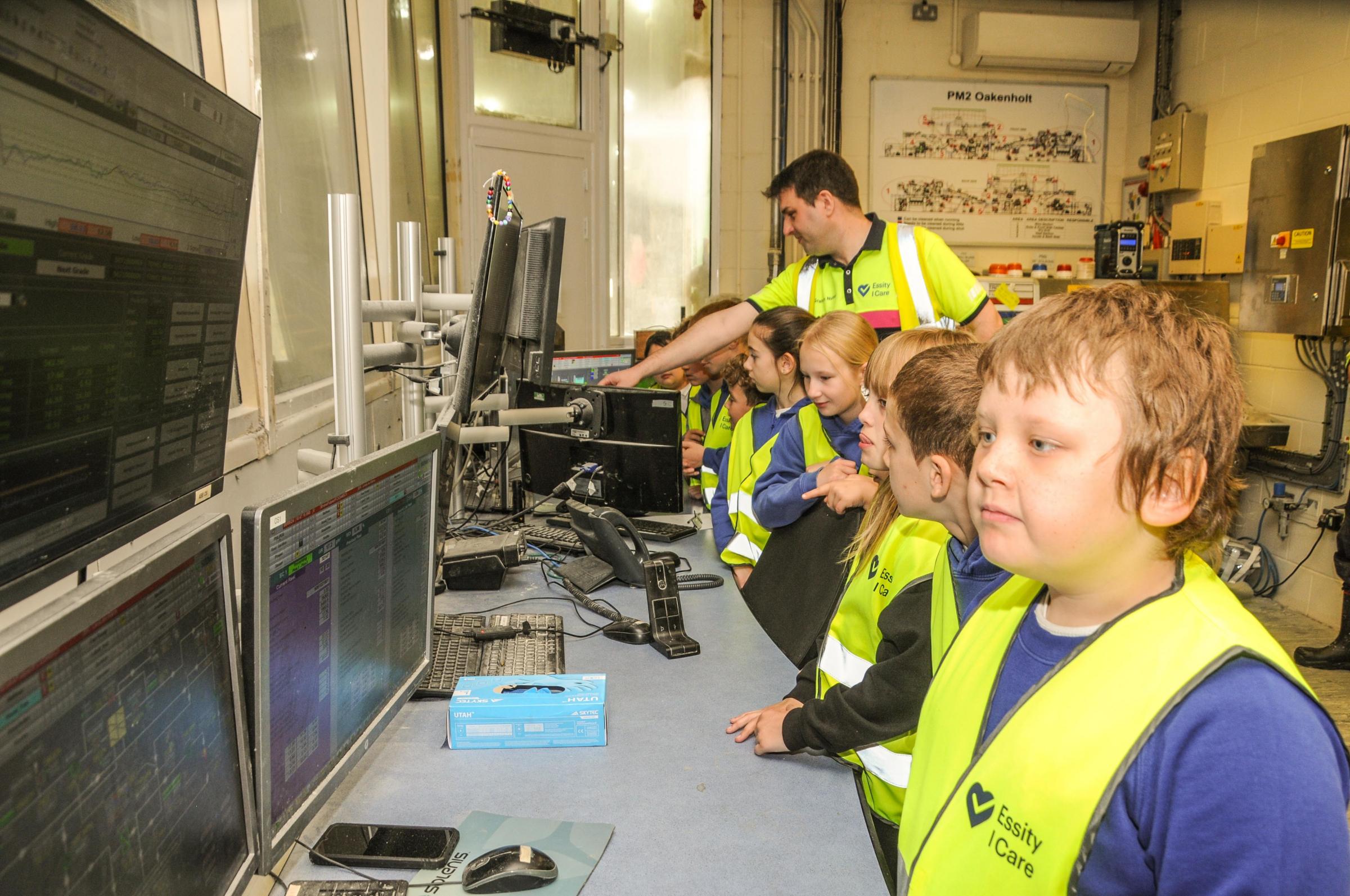 In the control room monitoring paper machine performance.