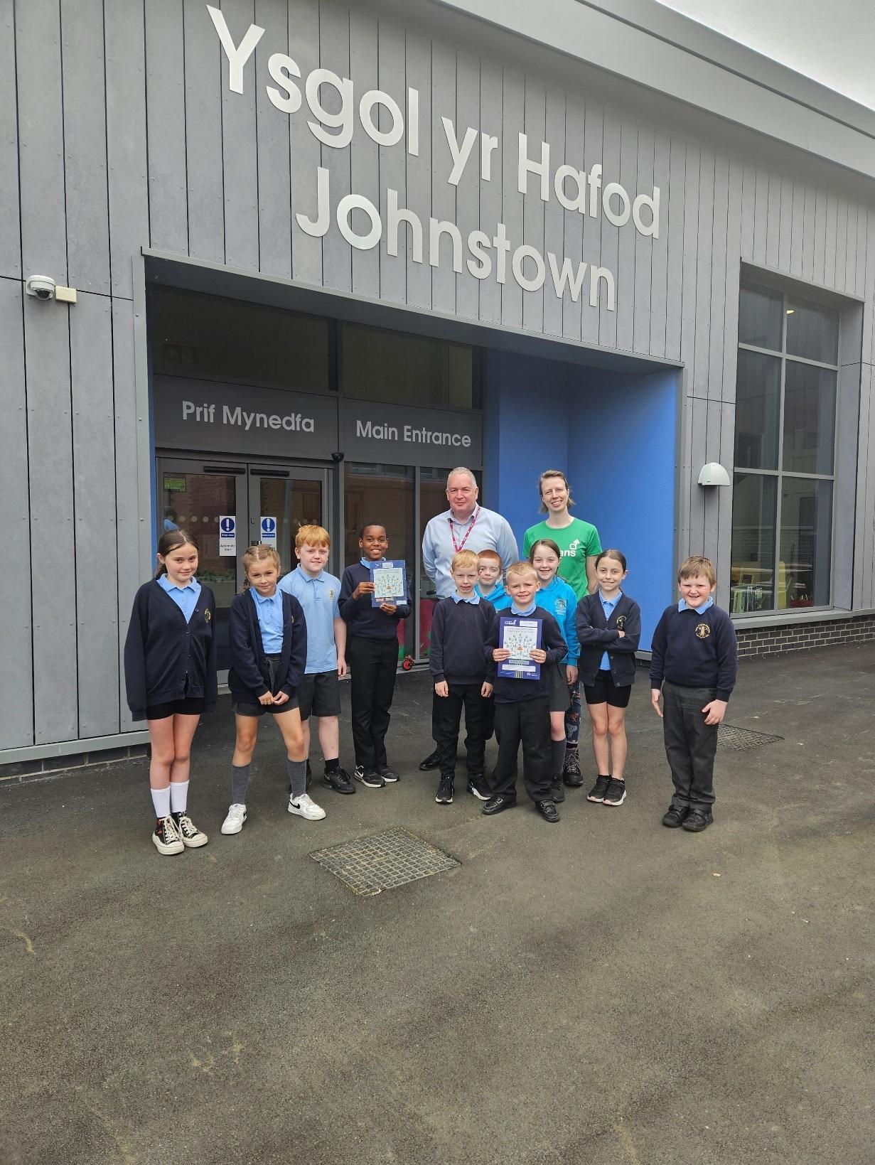 Ysgol Yr Hafod Eco Council receiving the Sustrans Silver award with chair of governors, Cllr David A Bithell and Hannah Meulman from Sustrans Cymru.