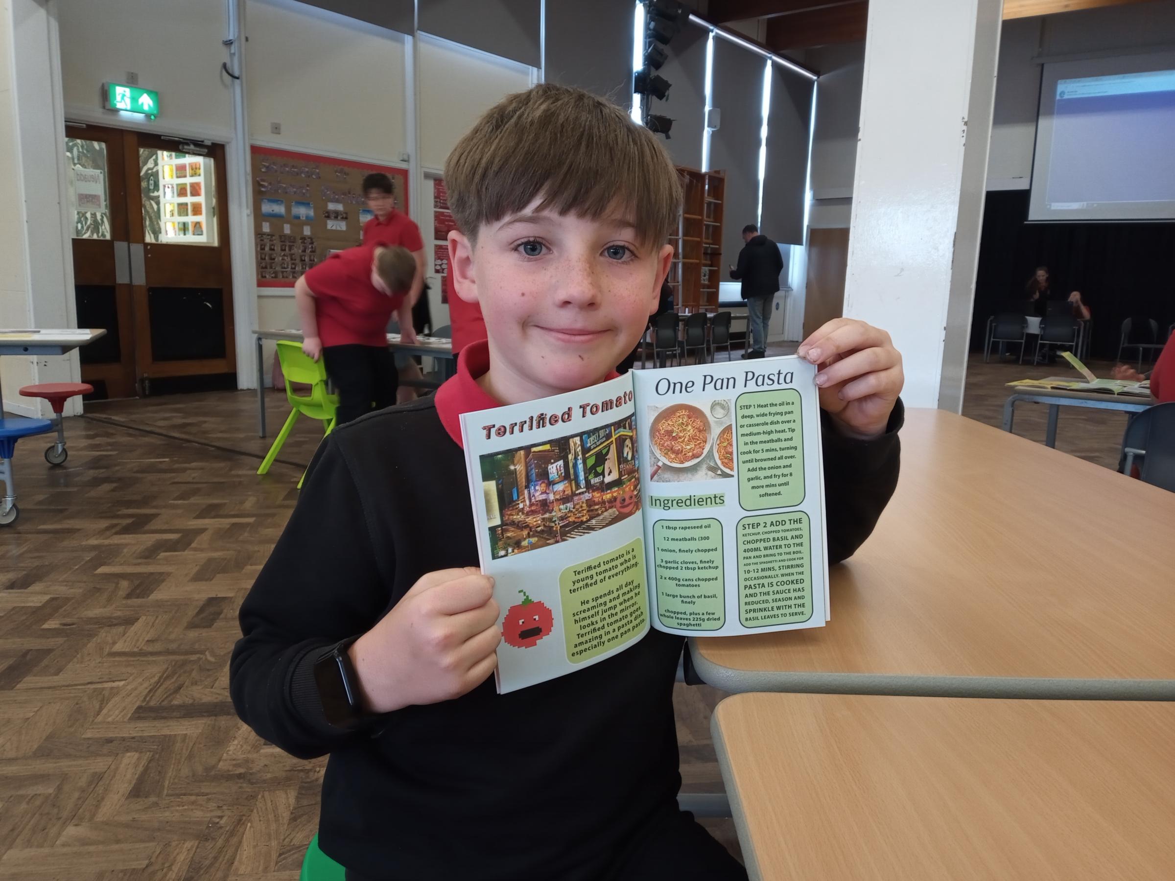 Archie Pitson, with his recipe featured in the schools book.