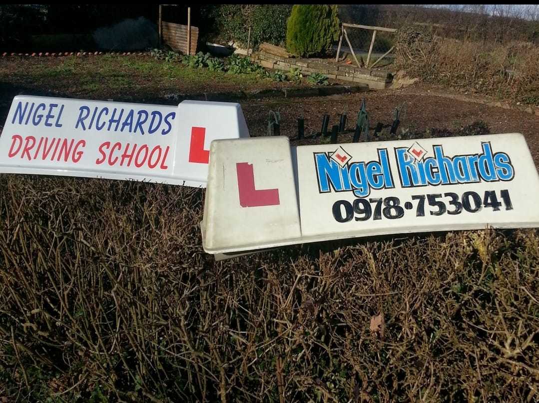 The very first rooftop signs for Nigel Richards Driving School.