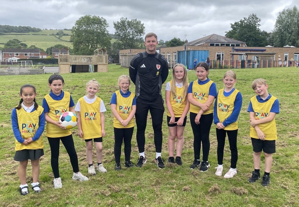 Jamie Crowther with Ysgol Derwenfa pupils during football sessions.