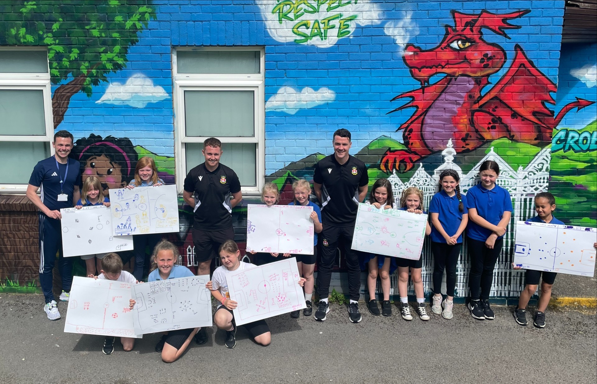 Ysgol Derwenfa deputy headteacher John Jones, with Dan Moore and Joe Culshaw, and pupils.