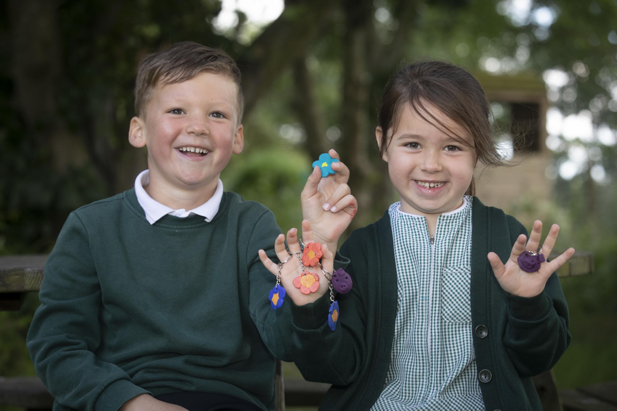 Jacob and Eva with some of the key rings and fridge magnets sold. Photo: Mandy Jones