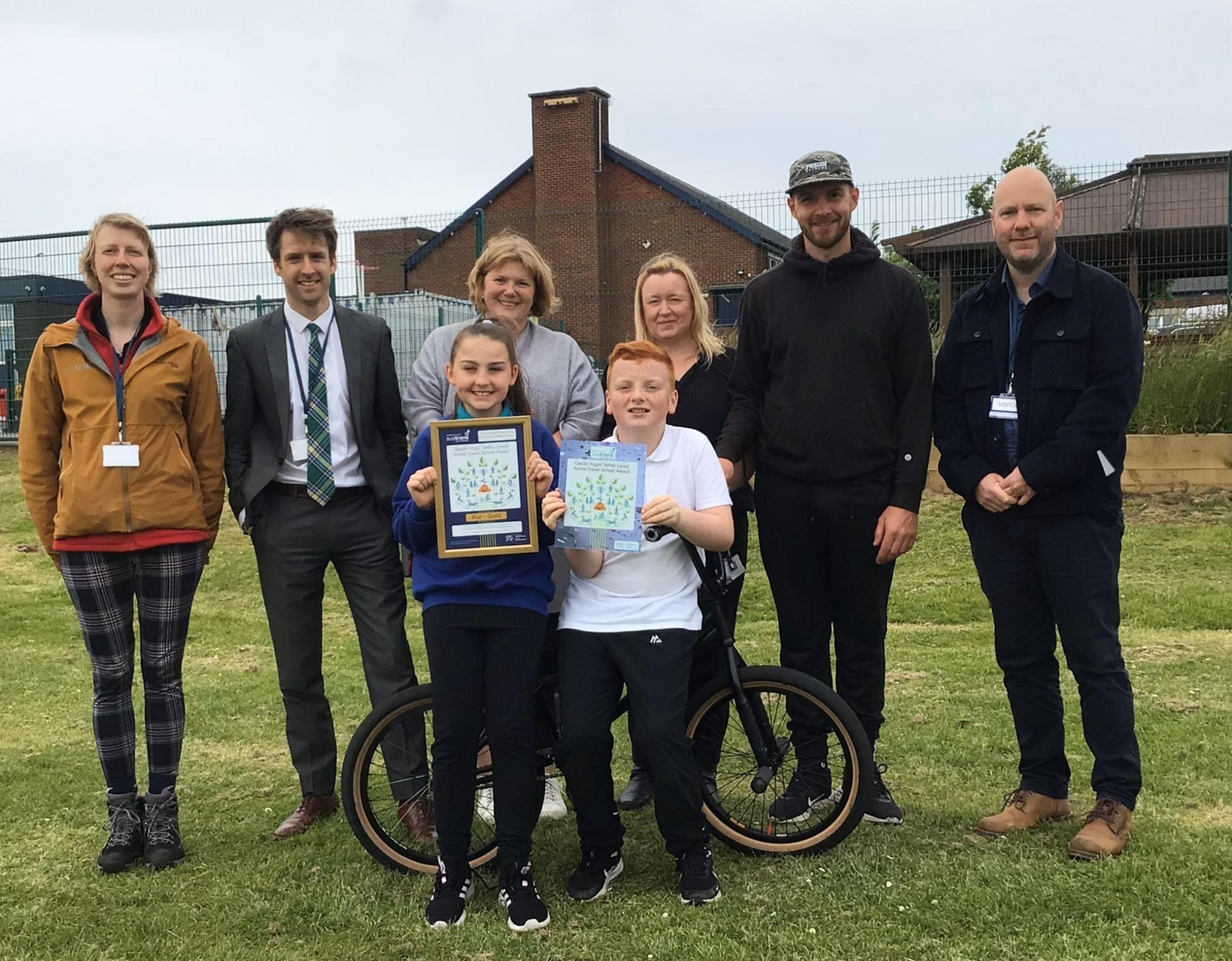 Sam Rowlands MS, with Hannah Meulman, Active Journeys officer, Sam, Mared Eastwood, Pam Clegg, Active Journeys Champion at school, Matti Hemmings-BMX rider, Fusion Extreme, Stephen Cunnah, Sustrans Cymru and front, Active Journeys Crew pupils from Year