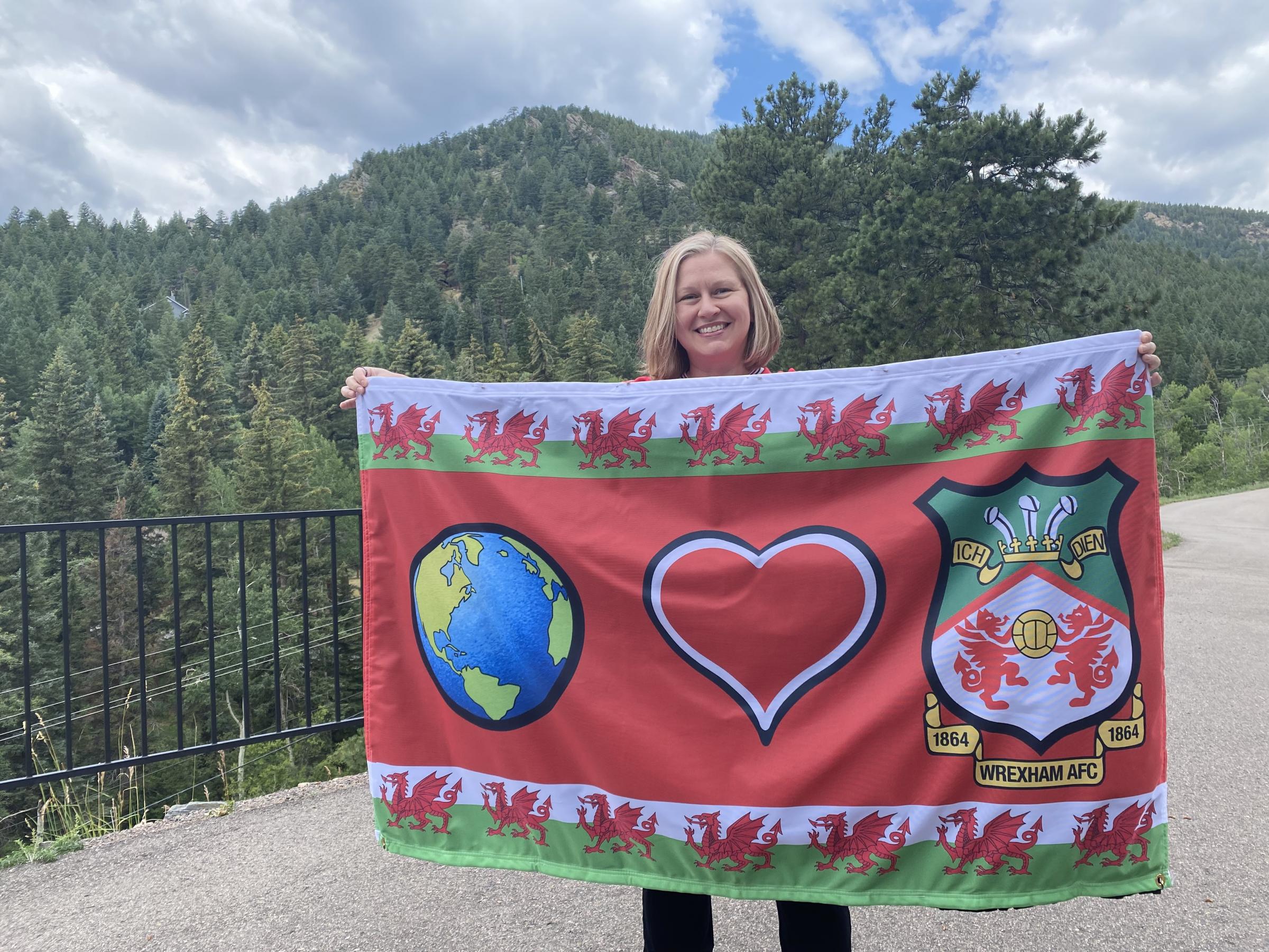 Sheri Hofling with the new flag she created to support the Reds.