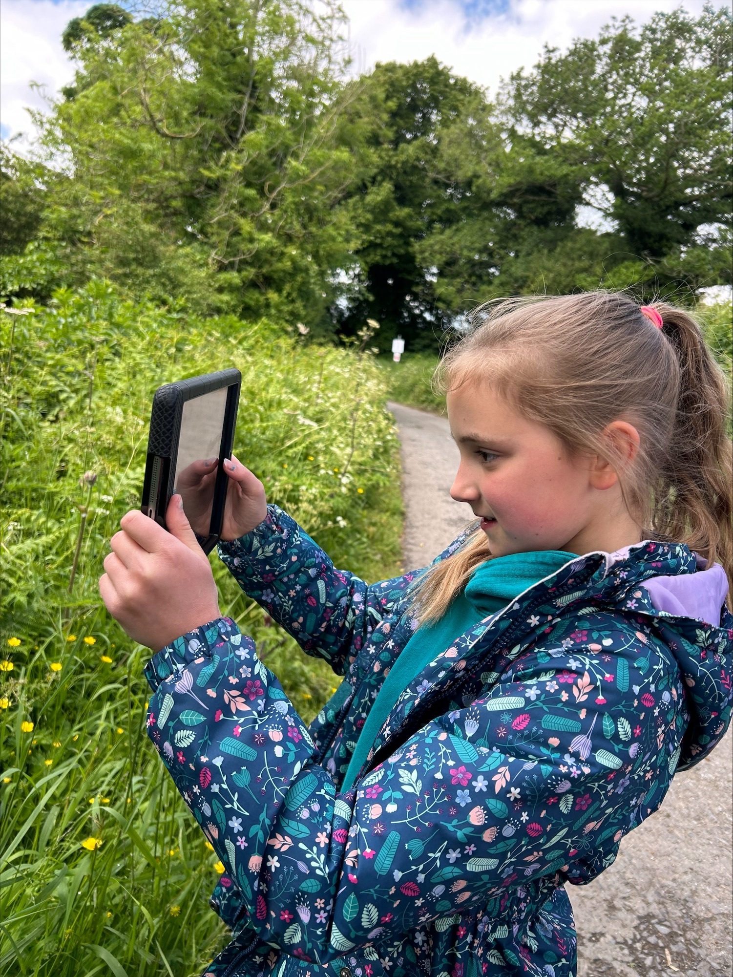 Grace filming for the video on a nature walk.