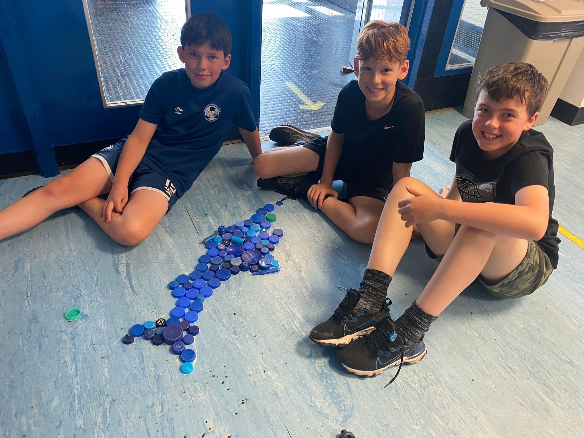 Josh Jones, Max Wood, and William Pae with their creation using items Tim Pugh, Environmental Artist, collected from beaches.