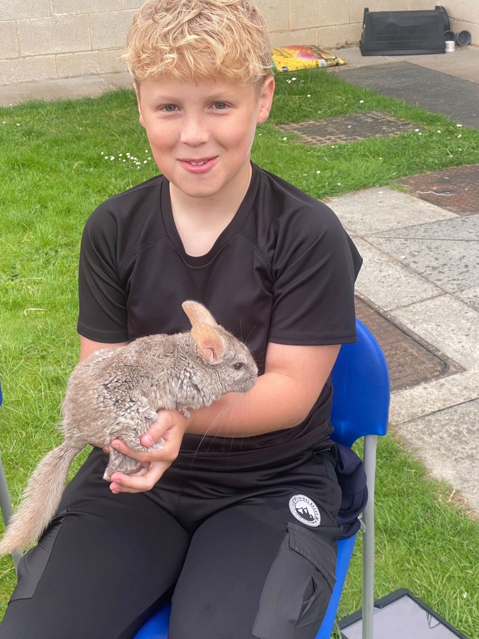 Evan Cooper with a chinchilla during an animal visit.