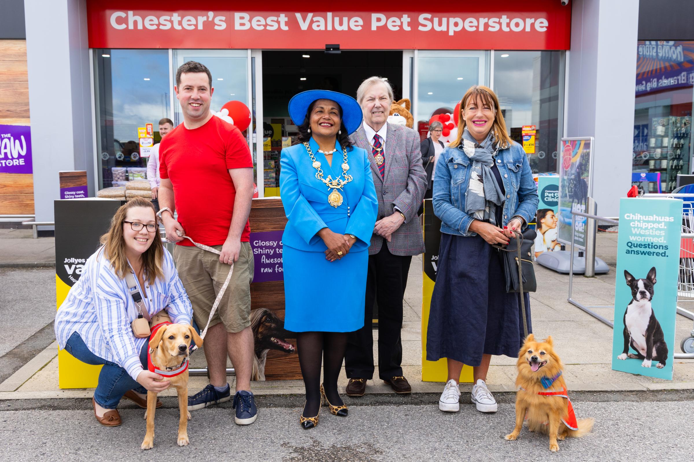 Celebrating the opening of the new Jollyes store were Lord Mayor of Chester, Cllr Razia Daniels and border force detector dog Sully and his handler Olivia Uguz who bit through a string of sausages to declare the store open