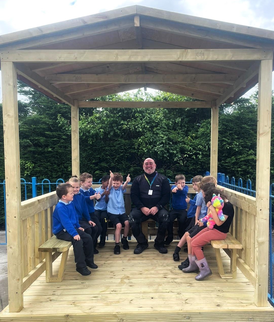 Mike Ward, a carpentry and joinery lecturer at Coleg Cambria, with pupils from The Rofft School.