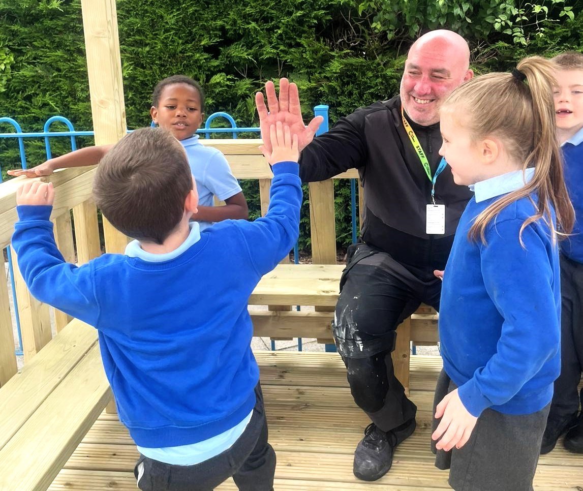 Mike Ward, a carpentry and joinery lecturer at Coleg Cambria, with pupils from The Rofft School.