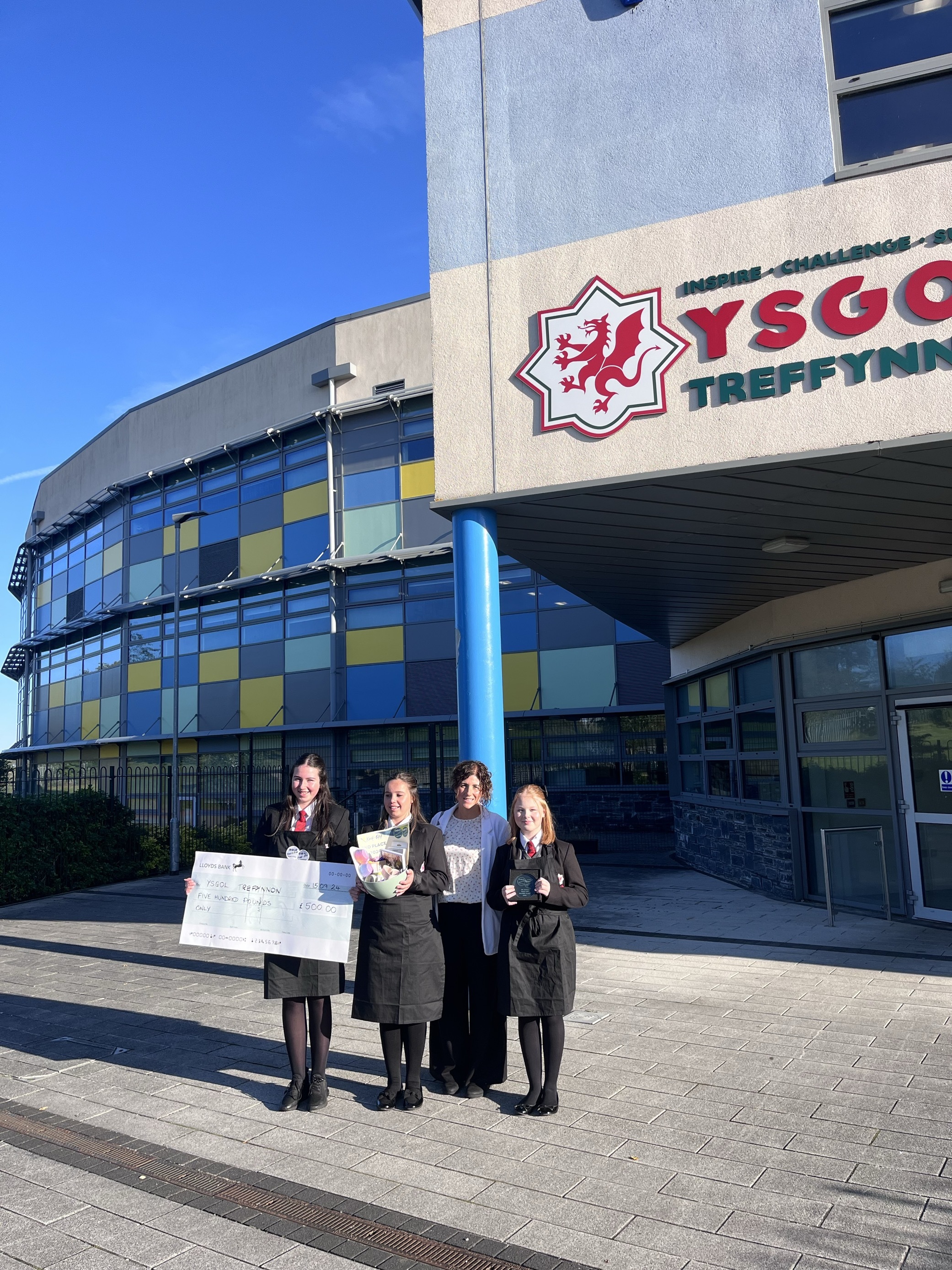 The girls with their trophy at Ysgol Treffynnon, and teacher Jenny Morris.