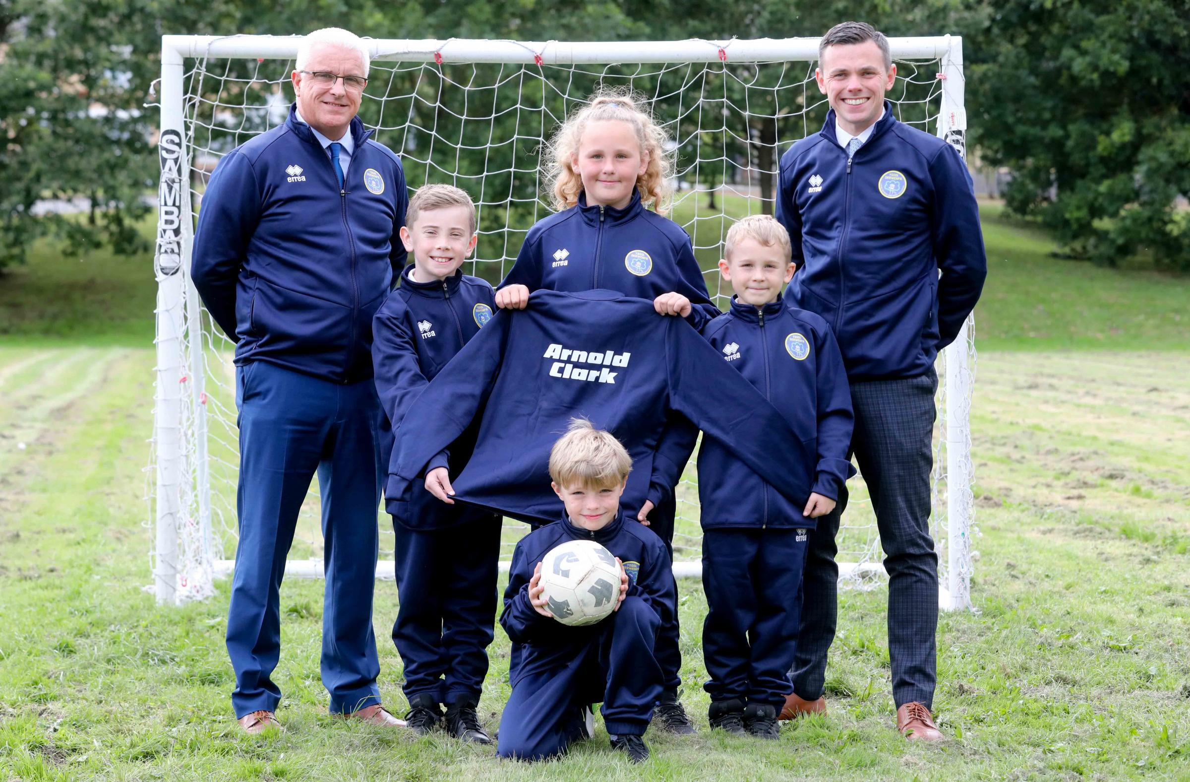 Headteacher Andrew Jones and deputy headteacher John Andrew Jones, with Jacob Weaver, Ava Couchman, Ethan Couchman and TJ Evans, with their new training kits sponsored by Arnold Clark. Photo: Rick Matthews Photography