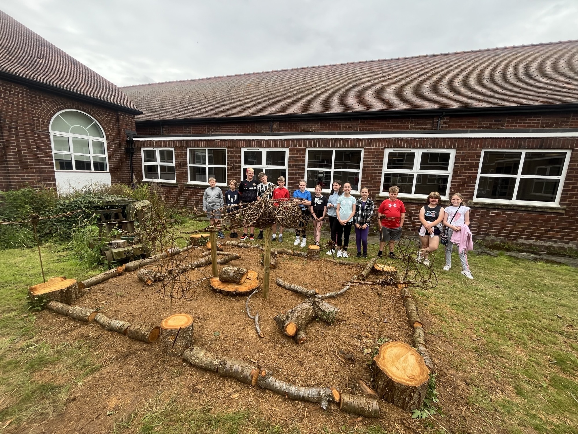 The children with their finished work in the quad garden.