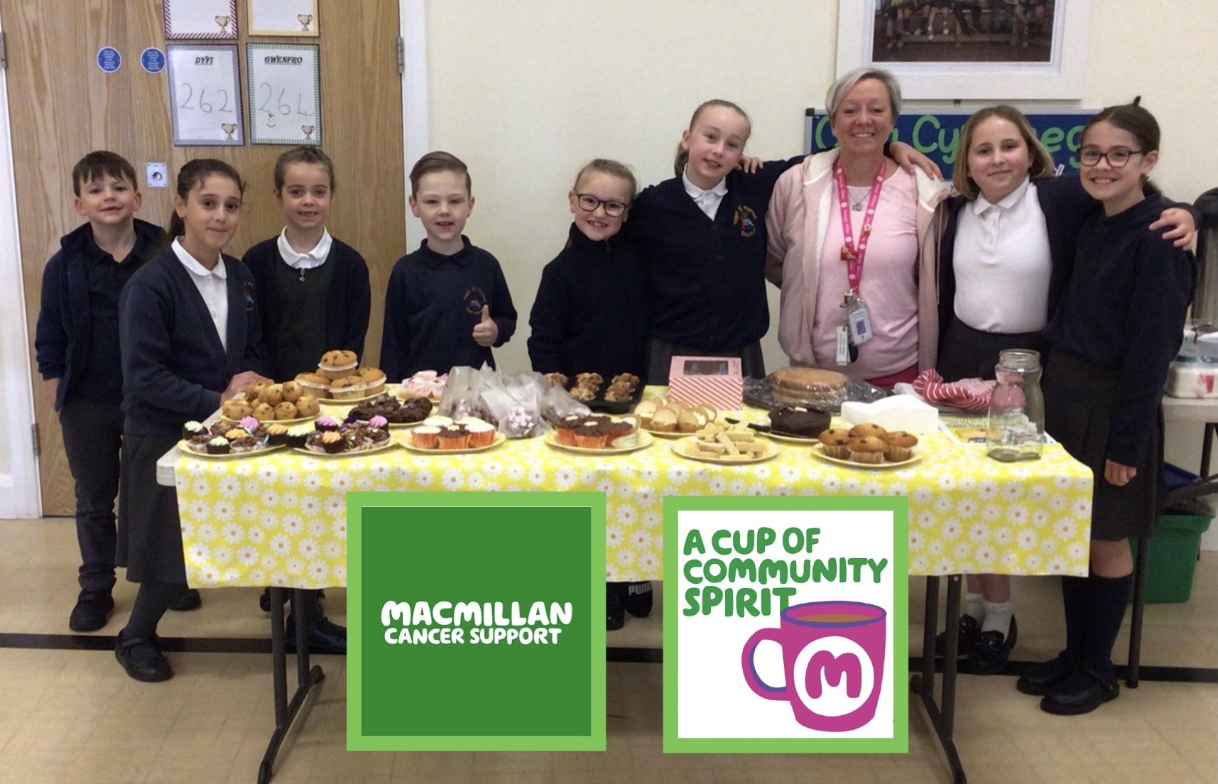 Teaching assistant Sue Bonney and members of the school council on the cake stall.