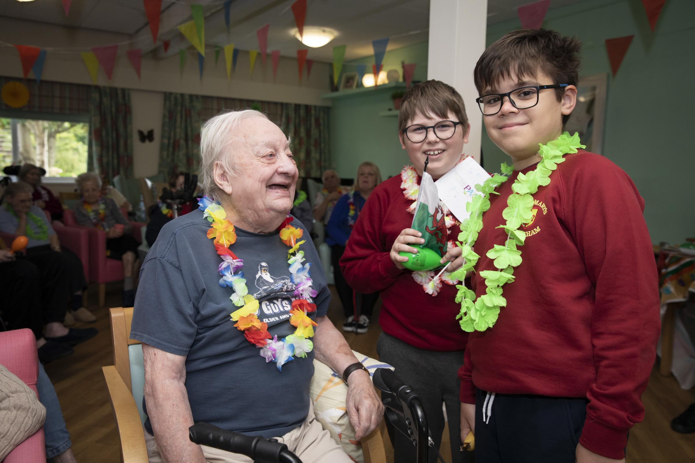 St Marys pupils Mark and Rodrigo with resident Peter Cotton. Photo: Mandy Jones